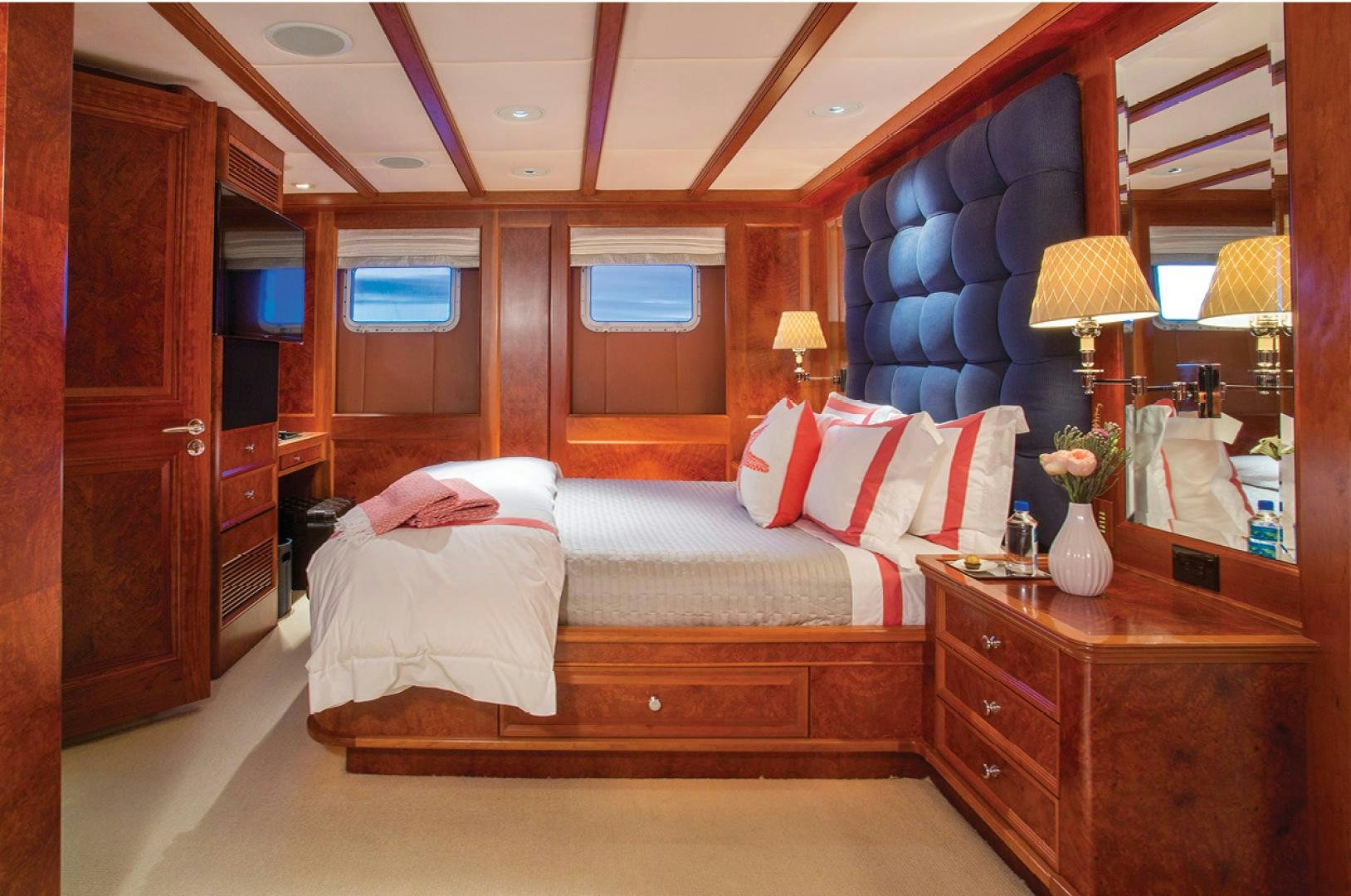 a bedroom with a bed and a desk aboard RHINO Yacht for Sale