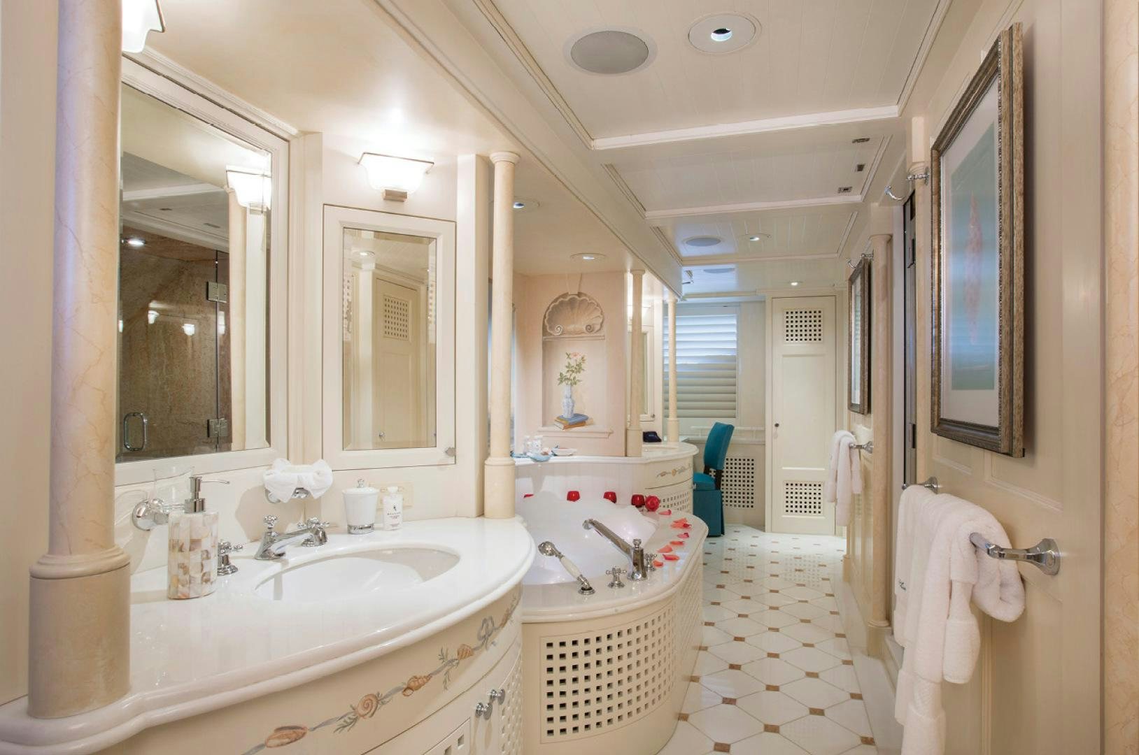 a bathroom with a tub sink and mirror aboard RHINO Yacht for Sale