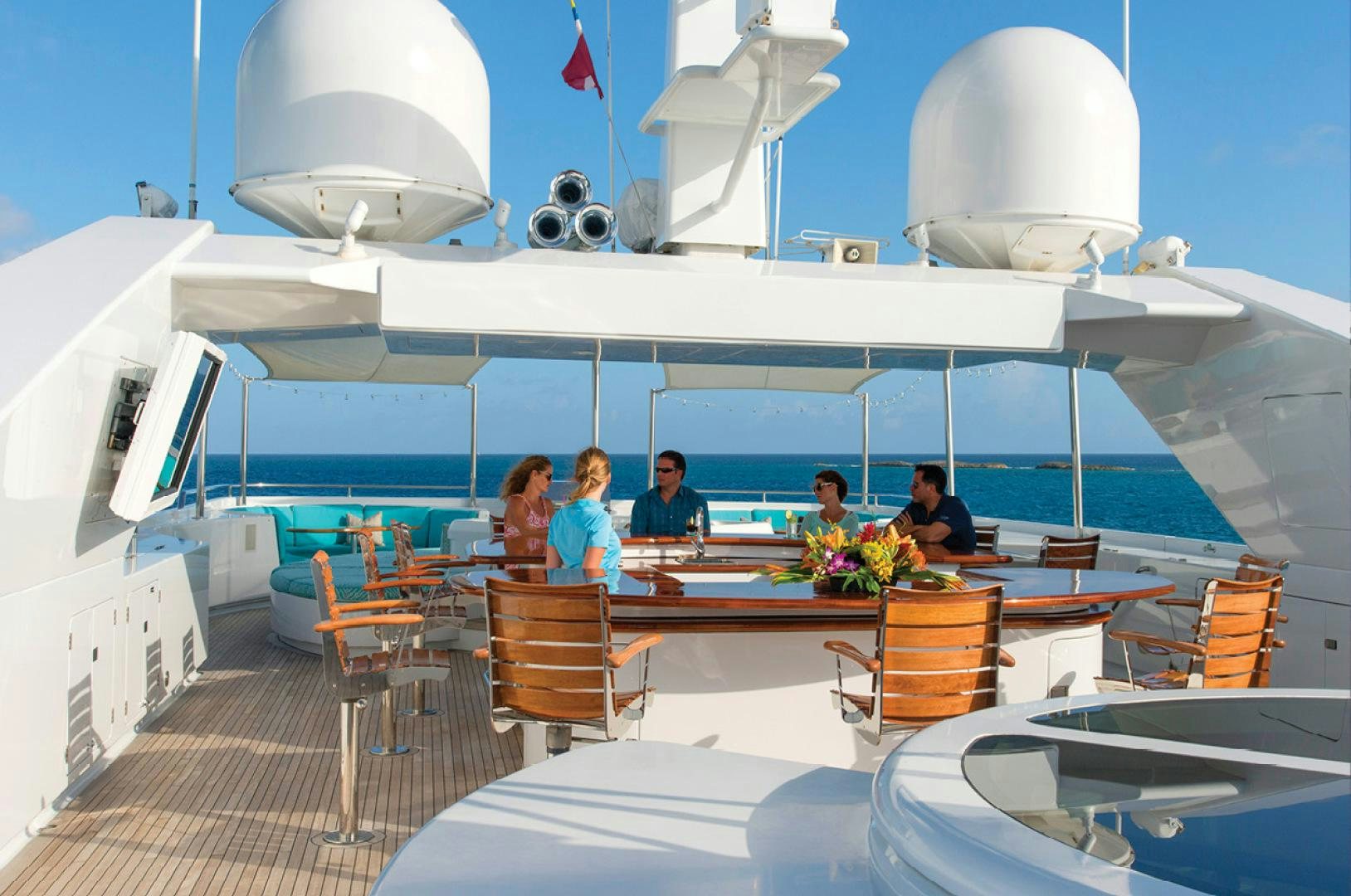 a group of people sitting at a table on a boat aboard RHINO Yacht for Sale