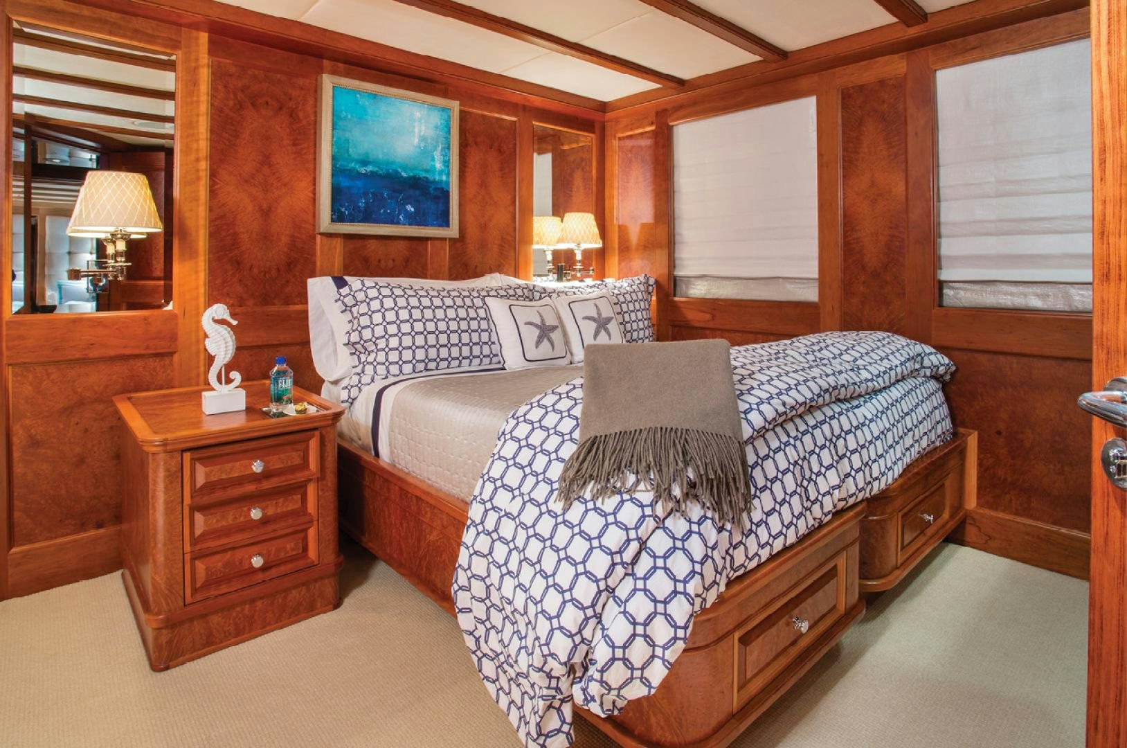 a bedroom with a bed and a dresser aboard RHINO Yacht for Sale