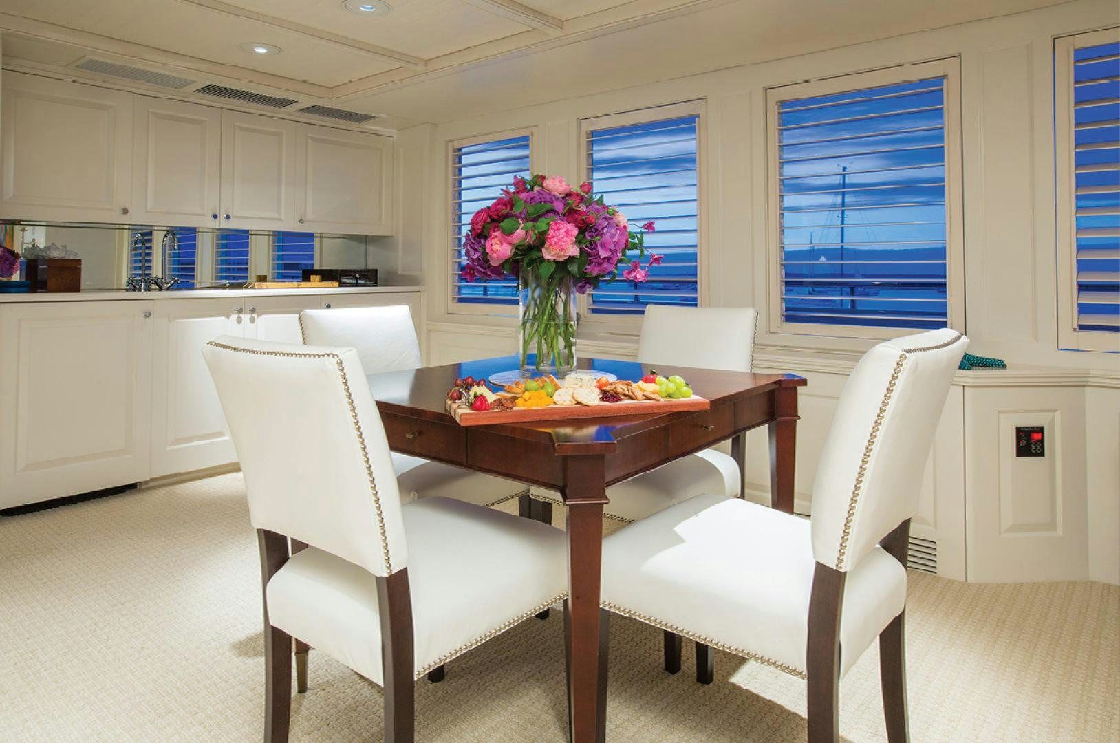 a table and chairs in a room aboard RHINO Yacht for Sale