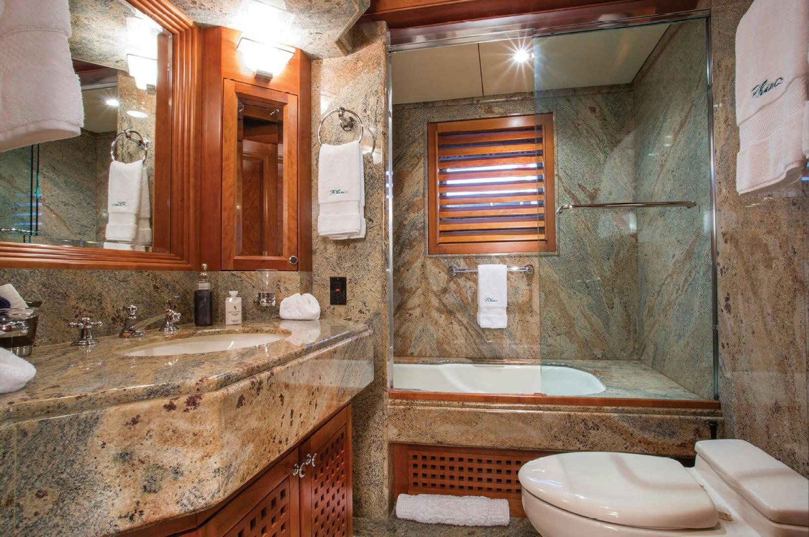 a bathroom with a marble countertop aboard RHINO Yacht for Sale