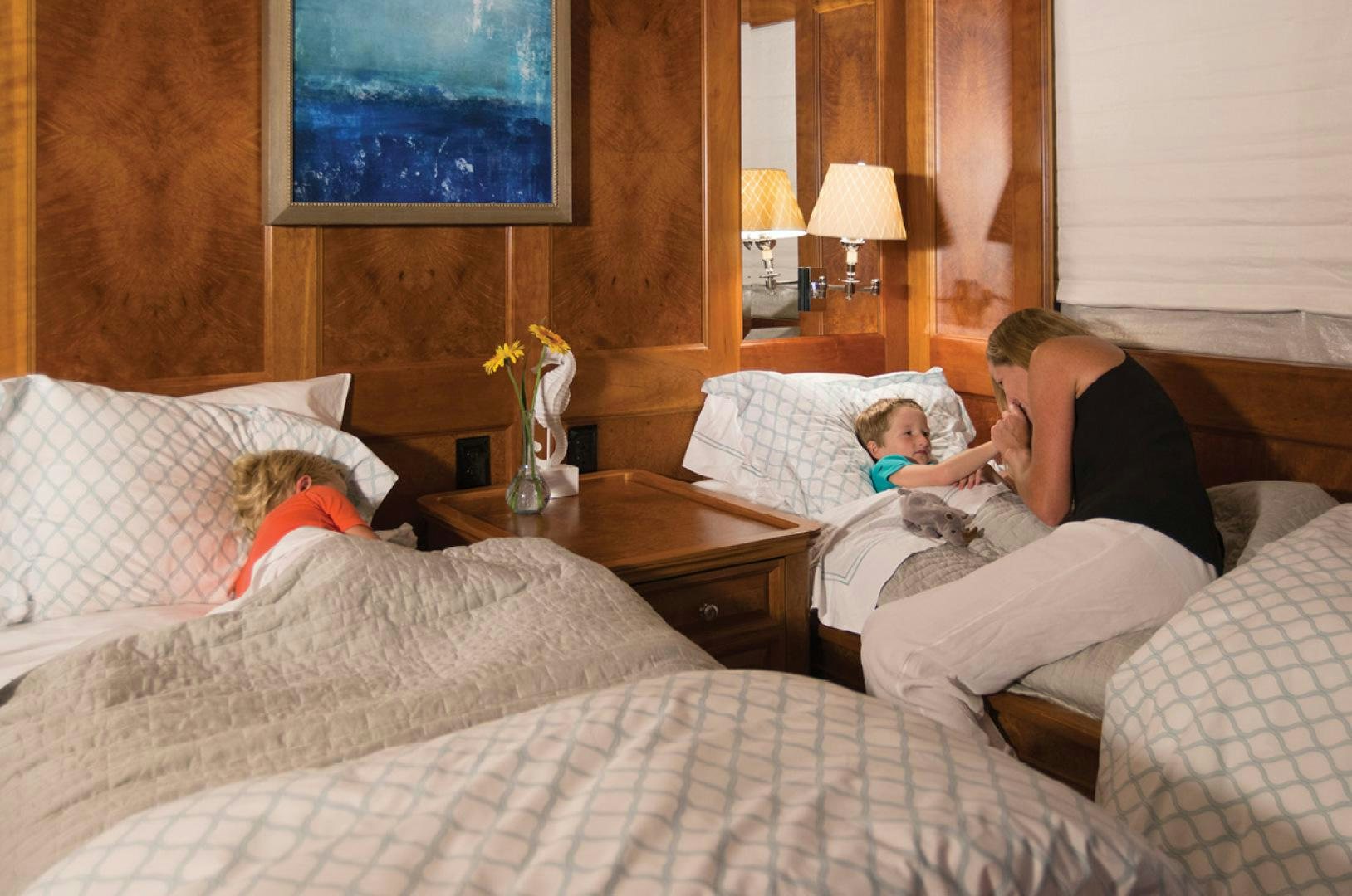 a person and a child on a bed aboard RHINO Yacht for Sale