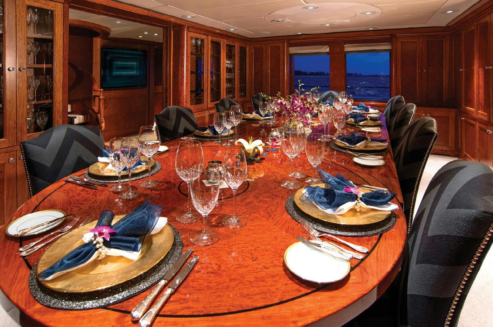 a table with plates and glasses aboard RHINO Yacht for Sale