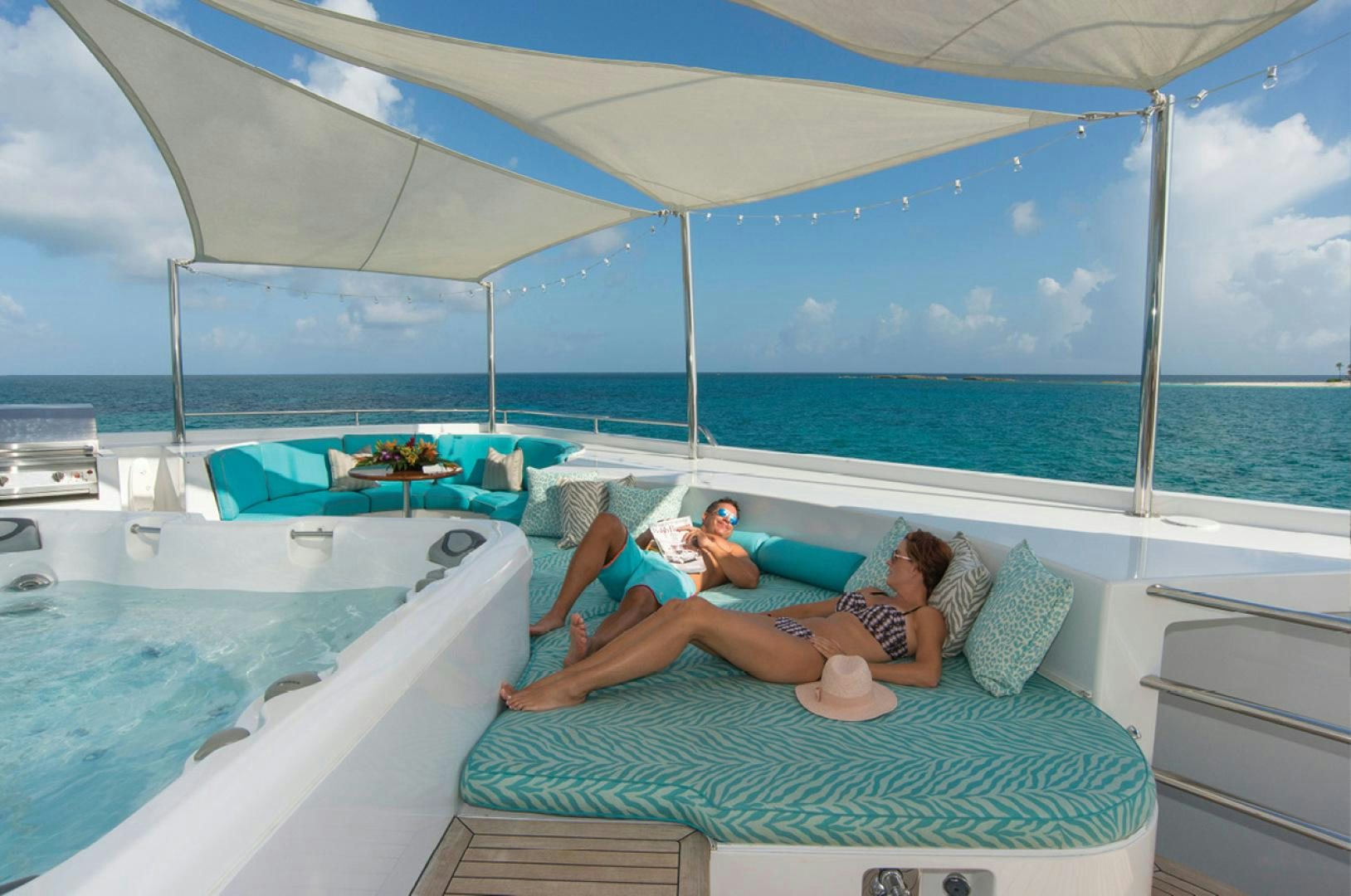 a group of people on a lounge chair on a boat aboard RHINO Yacht for Sale