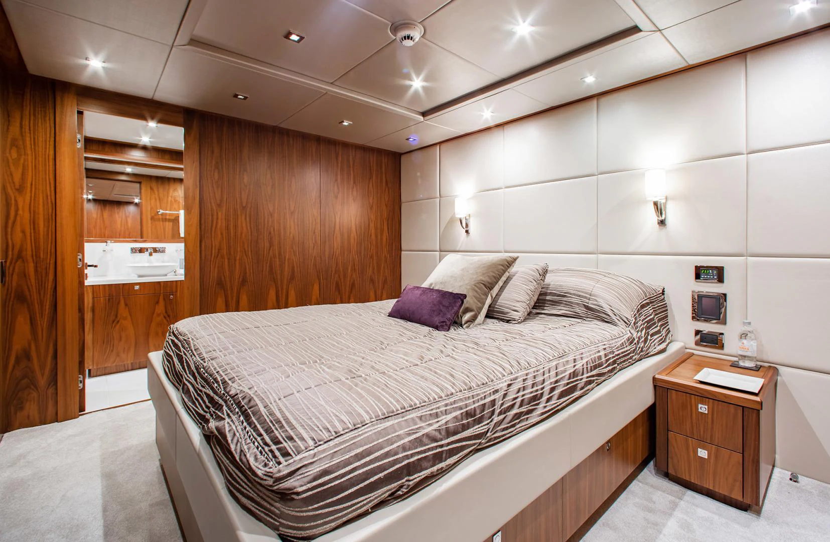 a bedroom with a bed and a desk aboard MARIN Yacht for Sale