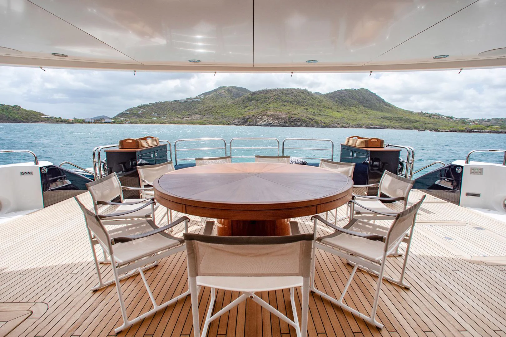a table and chairs on a deck overlooking a body of water aboard MARIN Yacht for Sale