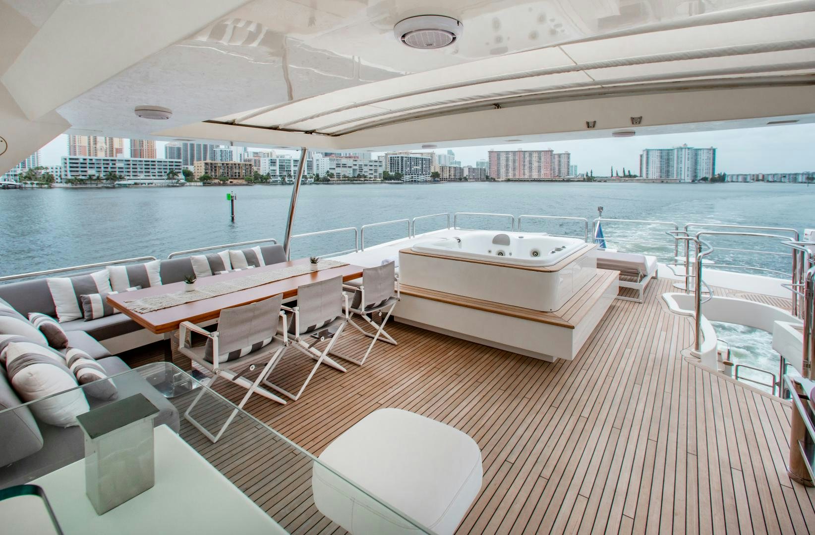 a lounge area with a bed and a large pool of water aboard ARREEE! Yacht for Sale