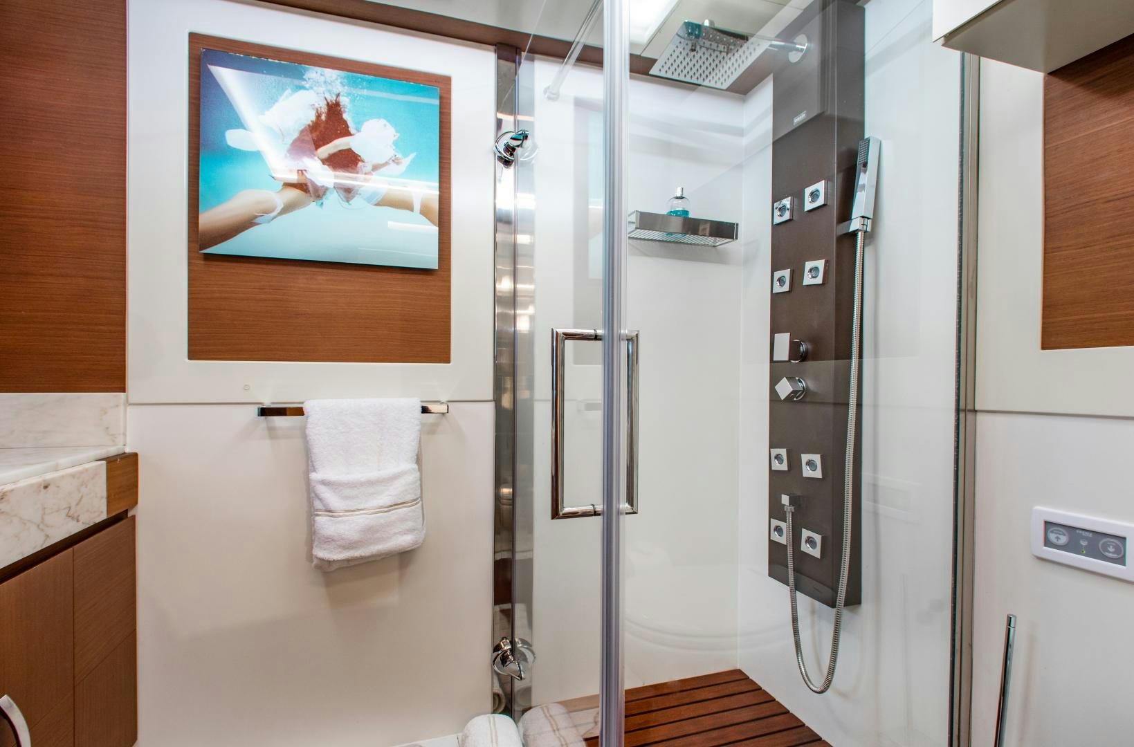 a bathroom with a shower unit and a picture on the wall aboard ARREEE! Yacht for Sale