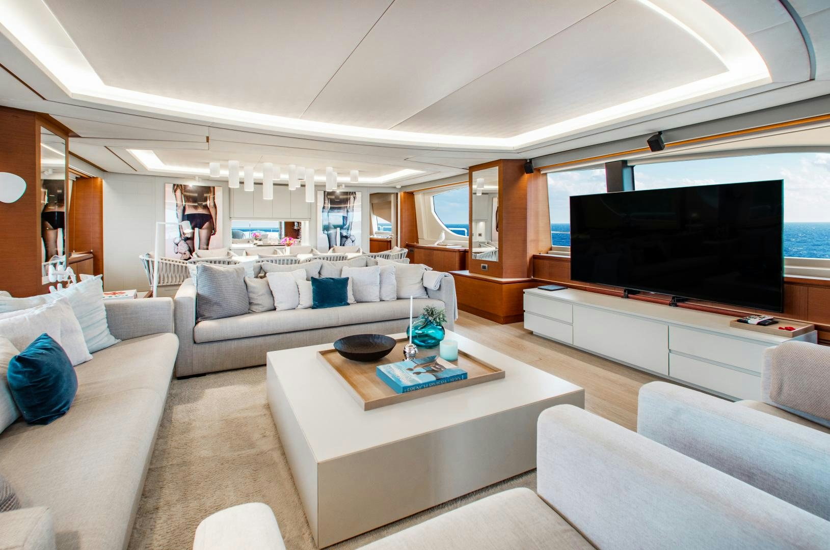 a living room with a large screen aboard ARREEE! Yacht for Sale