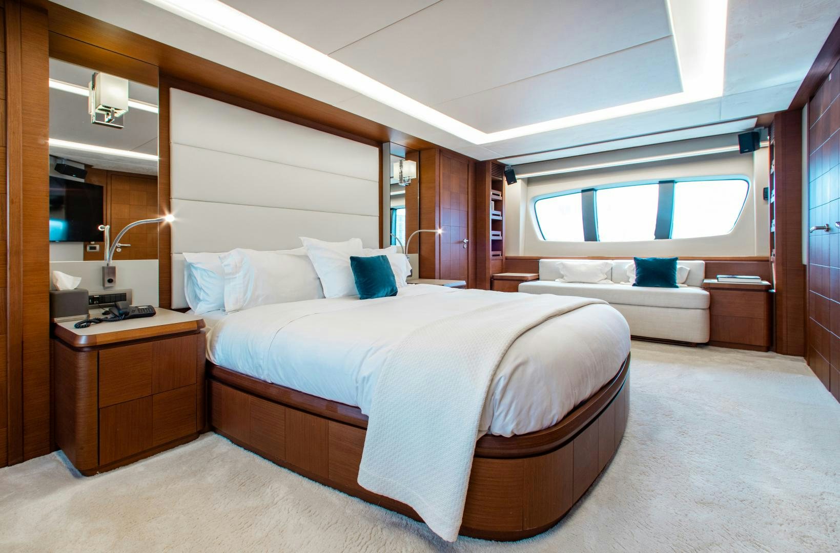 a room with a bed and a window aboard ARREEE! Yacht for Sale