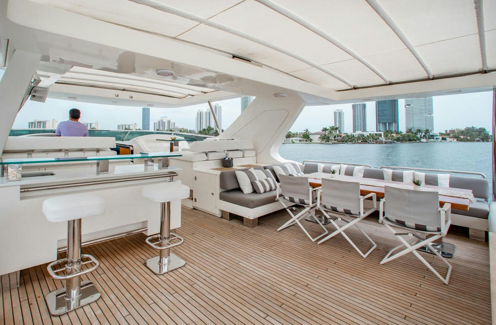 a room with a couch and a table and chairs aboard ARREEE! Yacht for Sale
