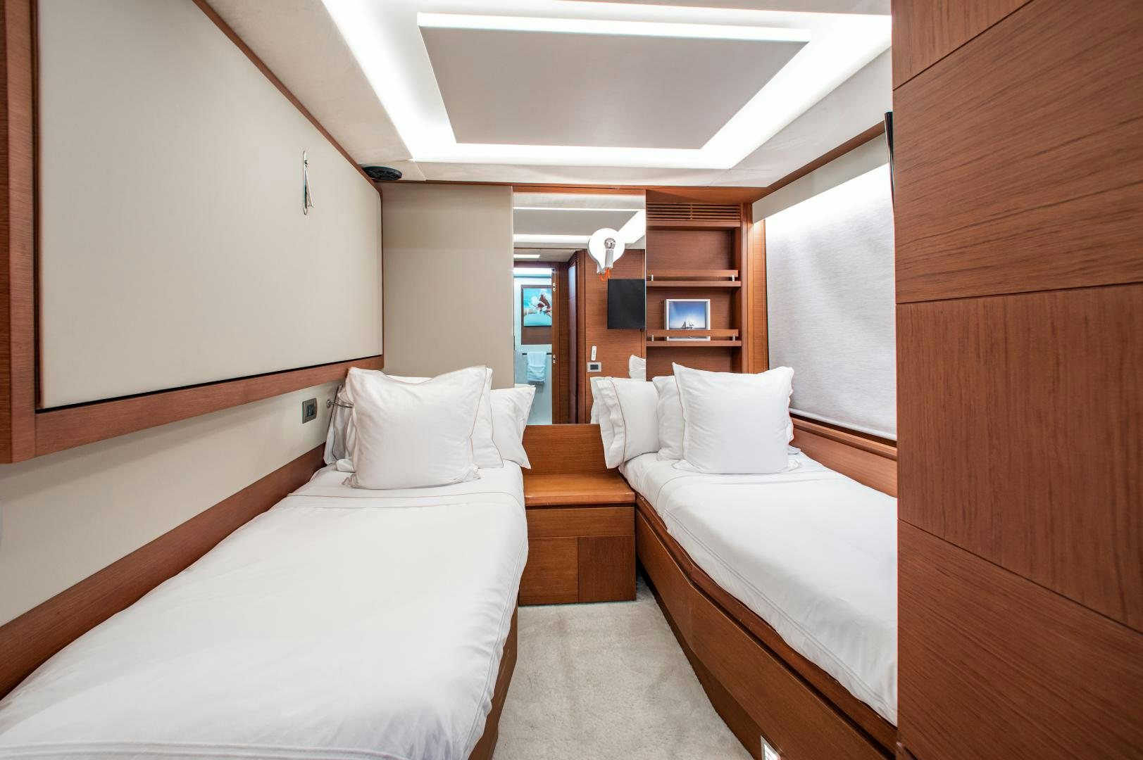 a room with a couple of beds aboard ARREEE! Yacht for Sale