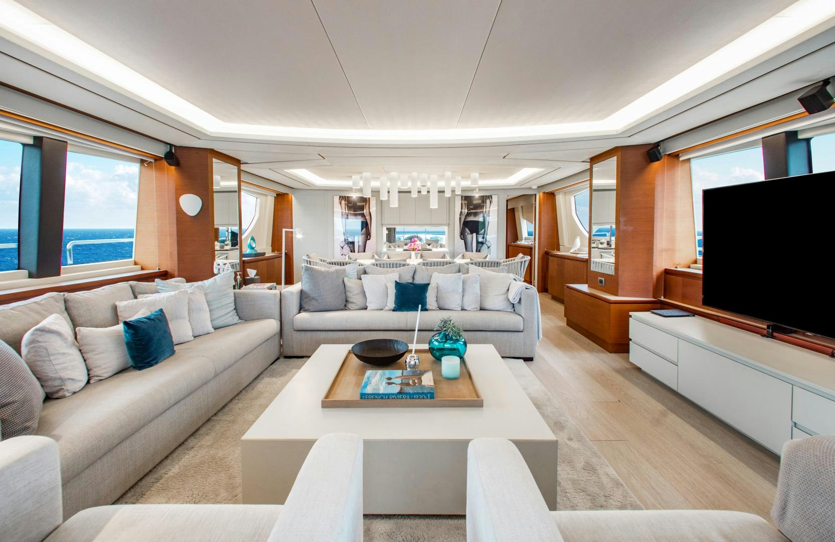 a living room with a white couch and a television aboard ARREEE! Yacht for Sale