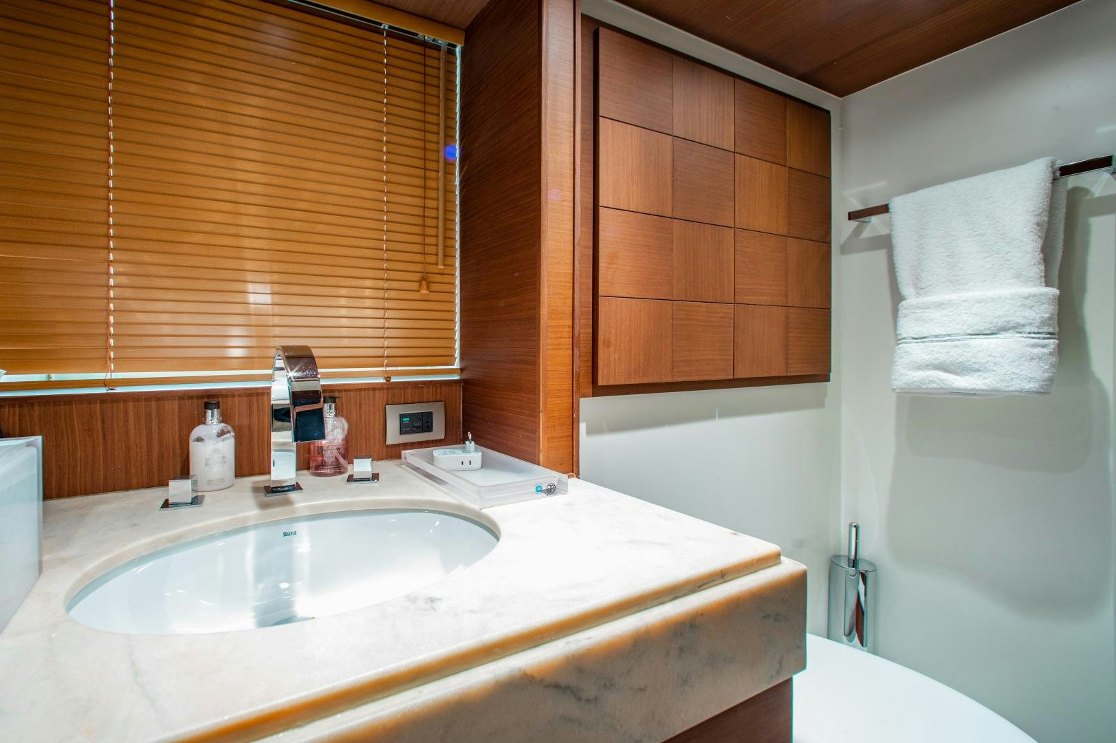 a bathroom with a sink and a mirror aboard ARREEE! Yacht for Sale