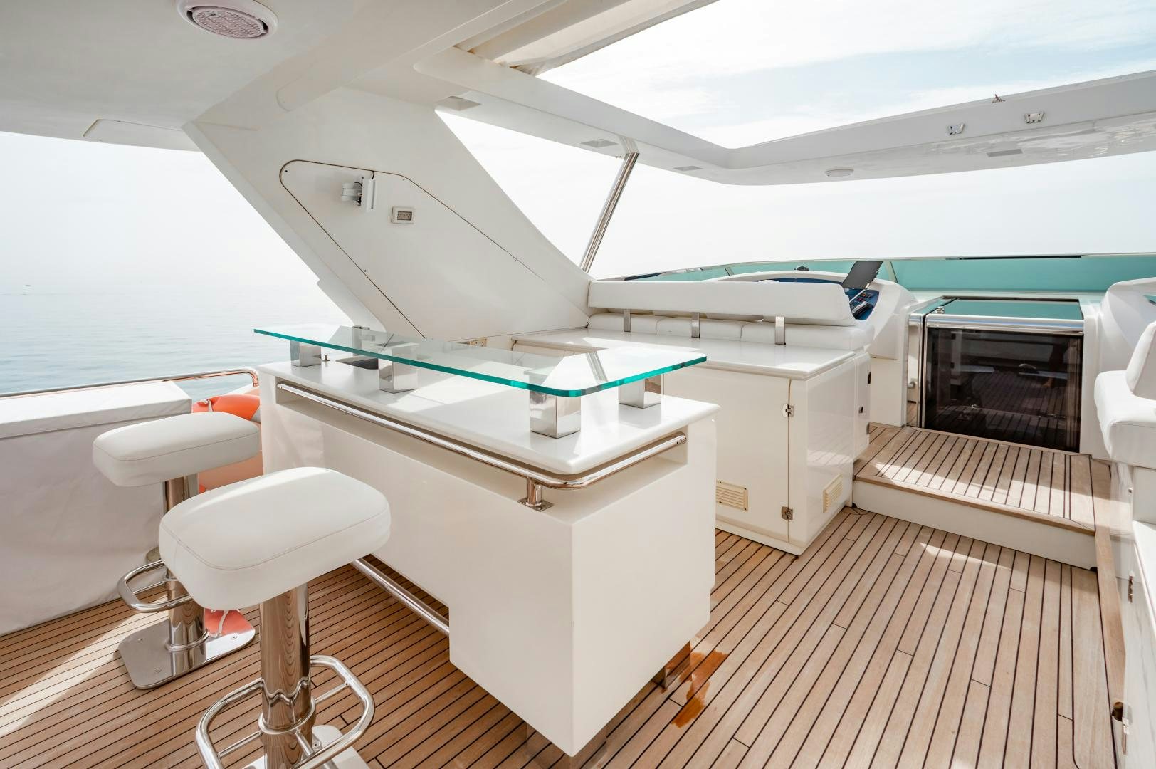 a room with a pool table and stools aboard ARREEE! Yacht for Sale