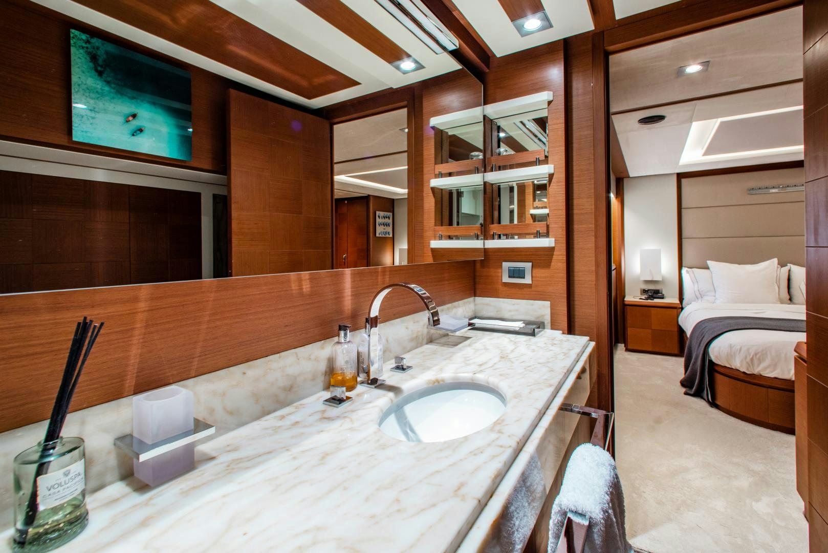 a bathroom with a sink and a bed aboard ARREEE! Yacht for Sale