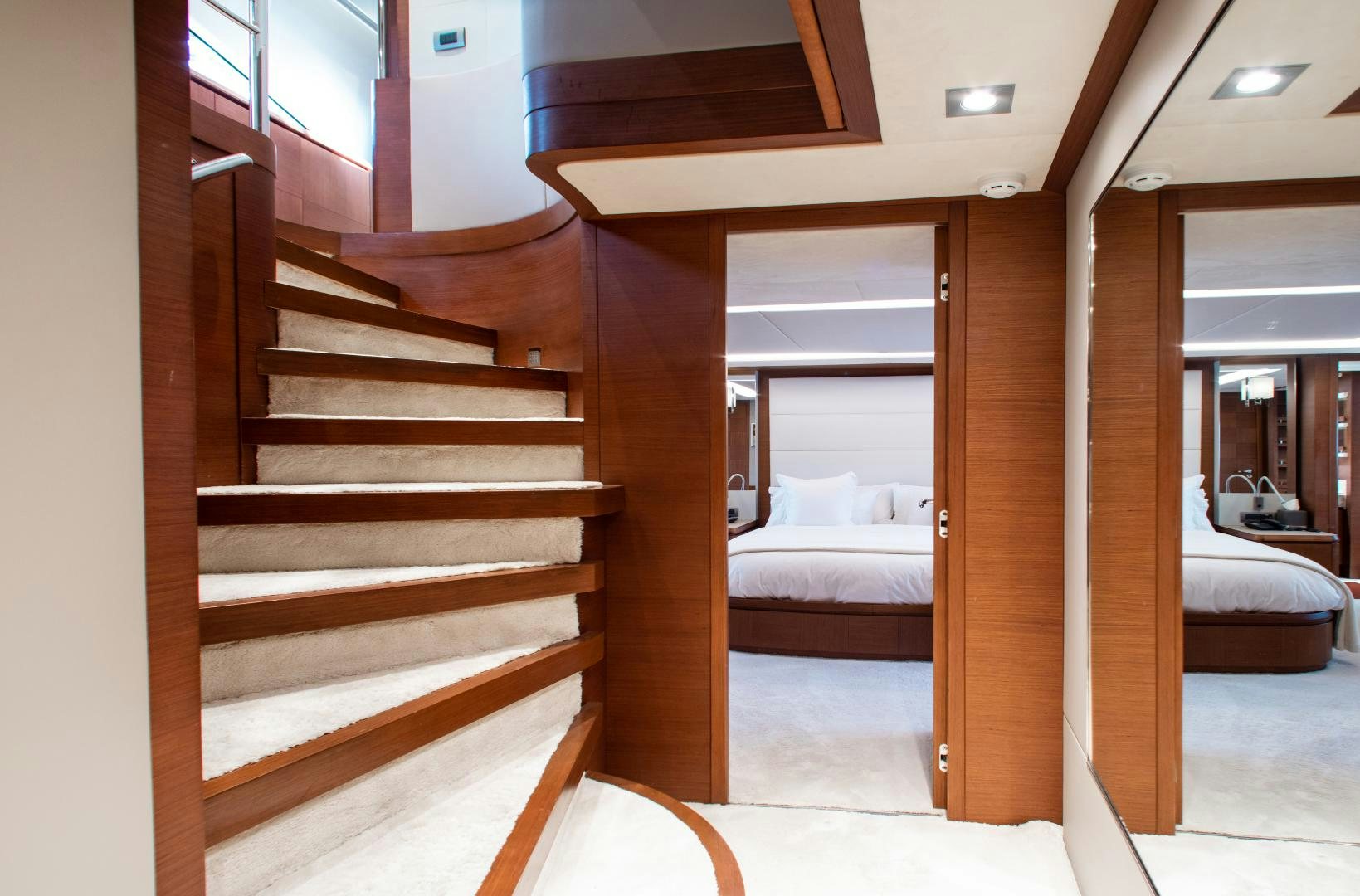 a wooden staircase in a room aboard ARREEE! Yacht for Sale