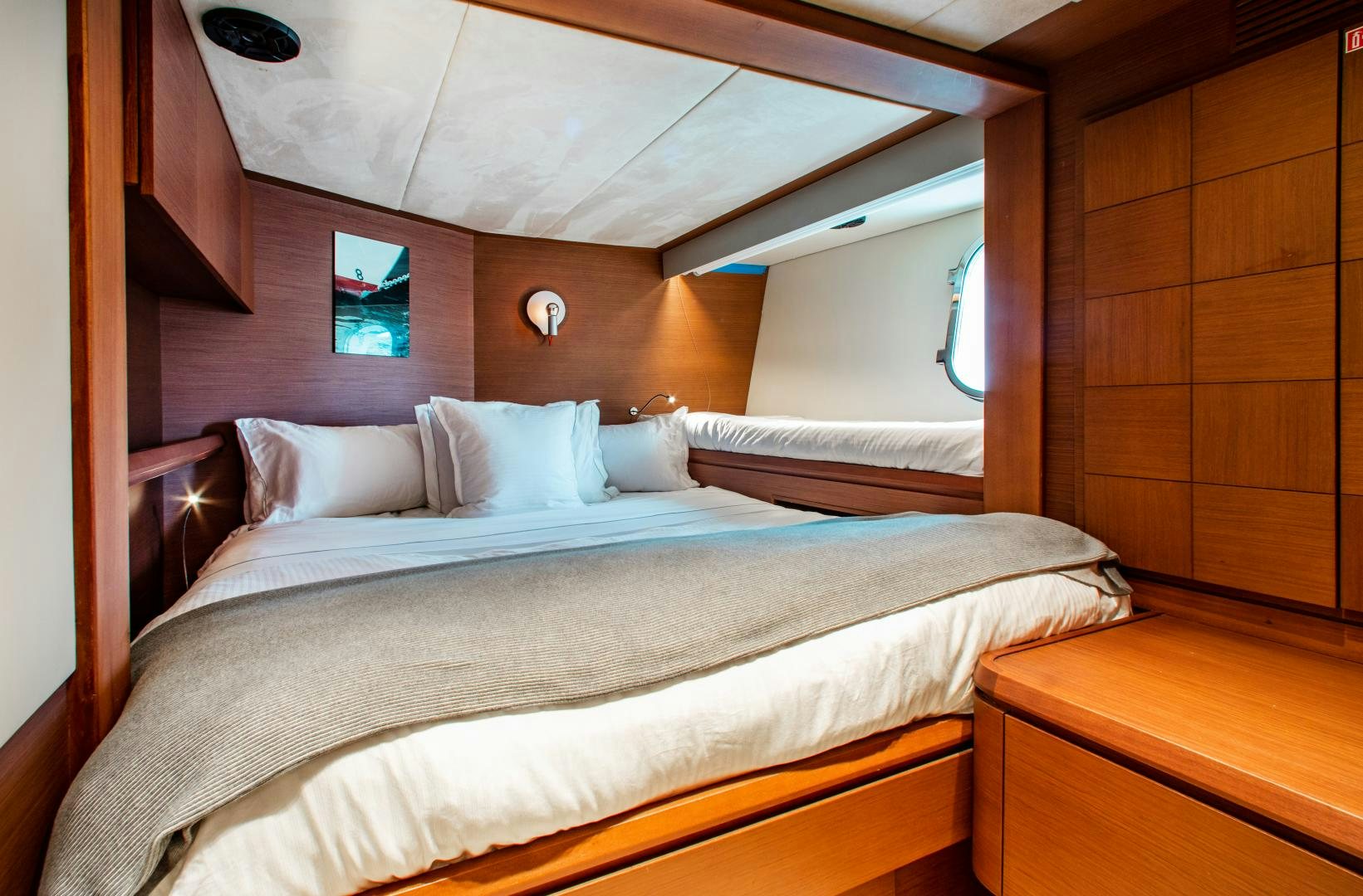 a bed with white sheets aboard ARREEE! Yacht for Sale