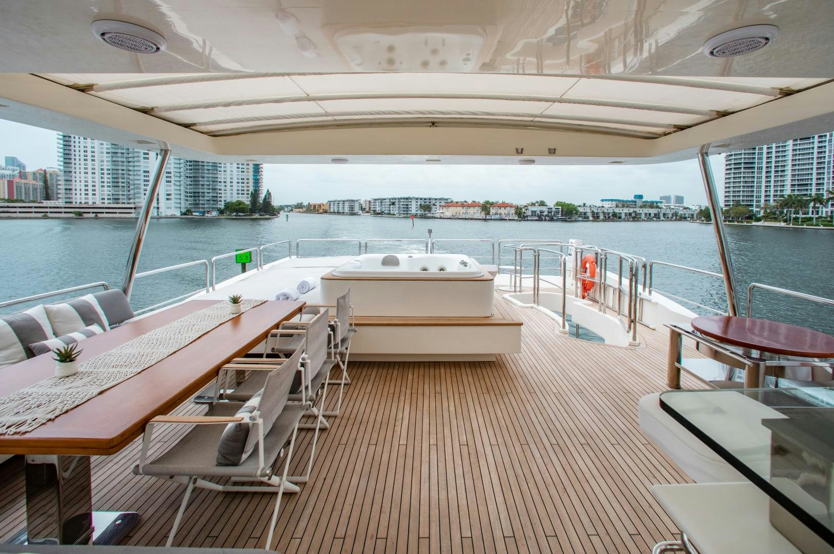 a deck with a view of a city and water aboard ARREEE! Yacht for Sale