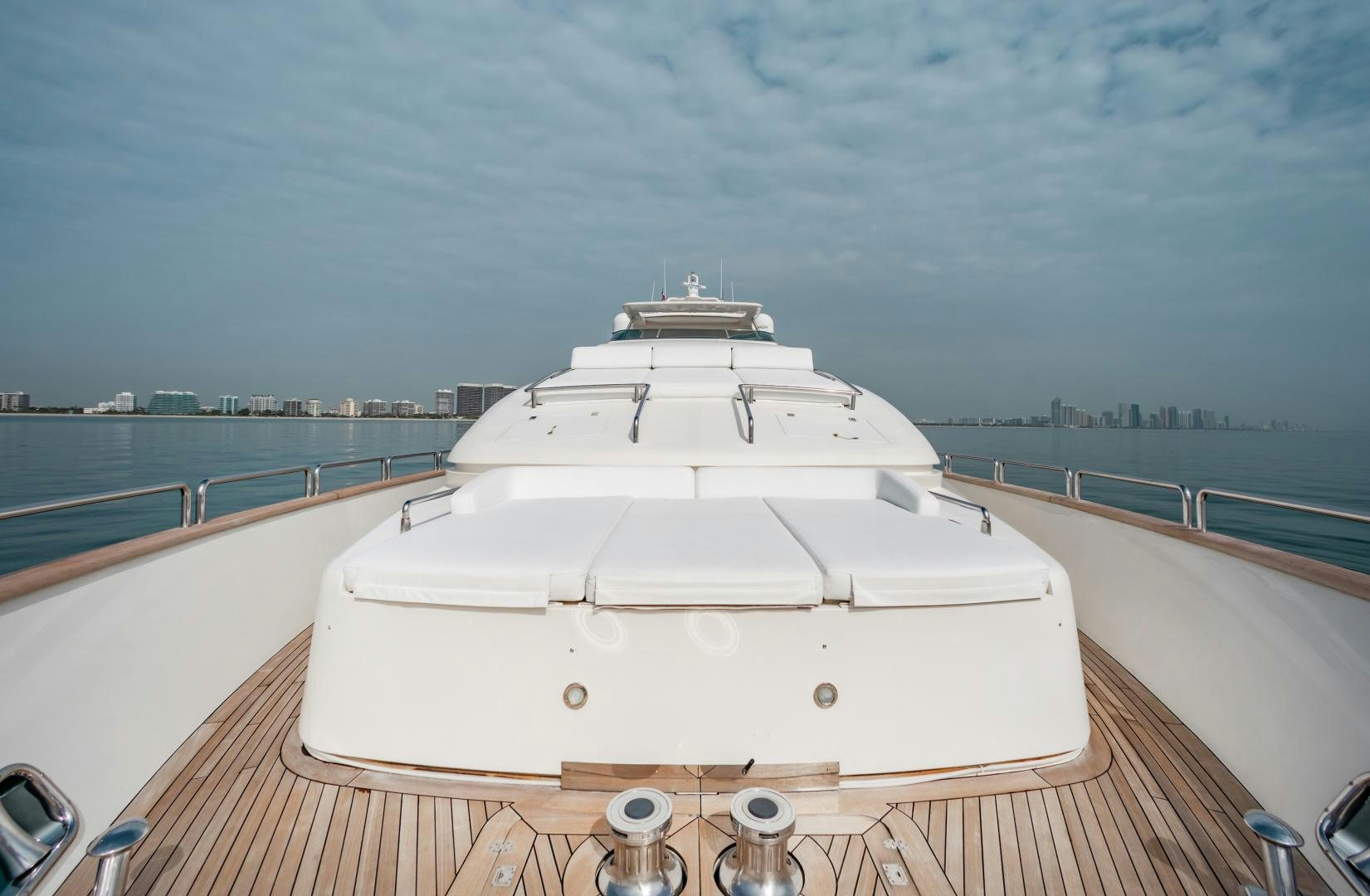 a white boat on a deck aboard ARREEE! Yacht for Sale