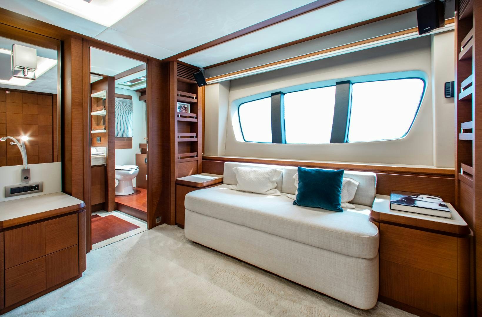 a bedroom with a bed and a window aboard ARREEE! Yacht for Sale