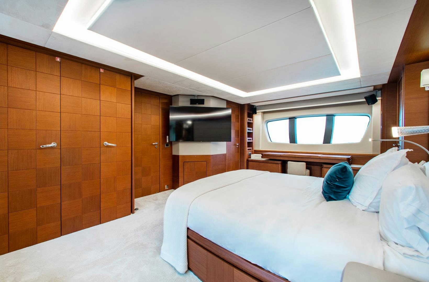 a room with a bed and a wood cabinet aboard ARREEE! Yacht for Sale
