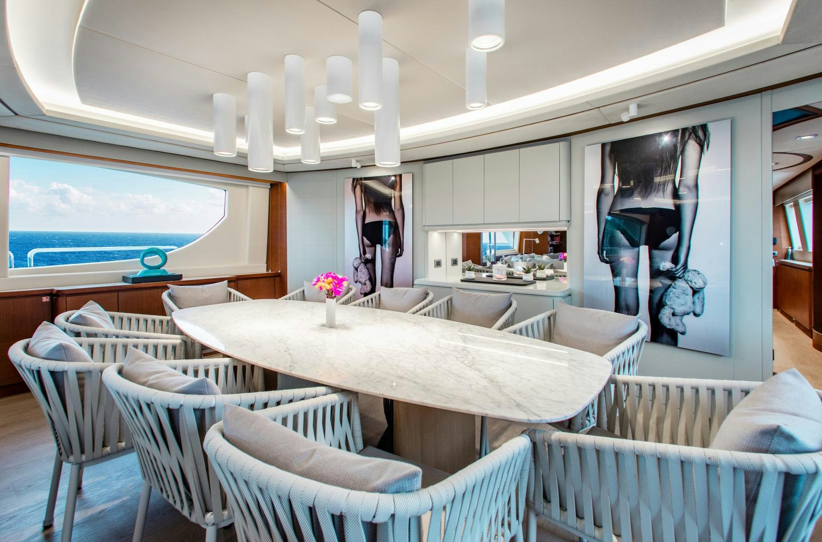 a room with chairs and tables aboard ARREEE! Yacht for Sale