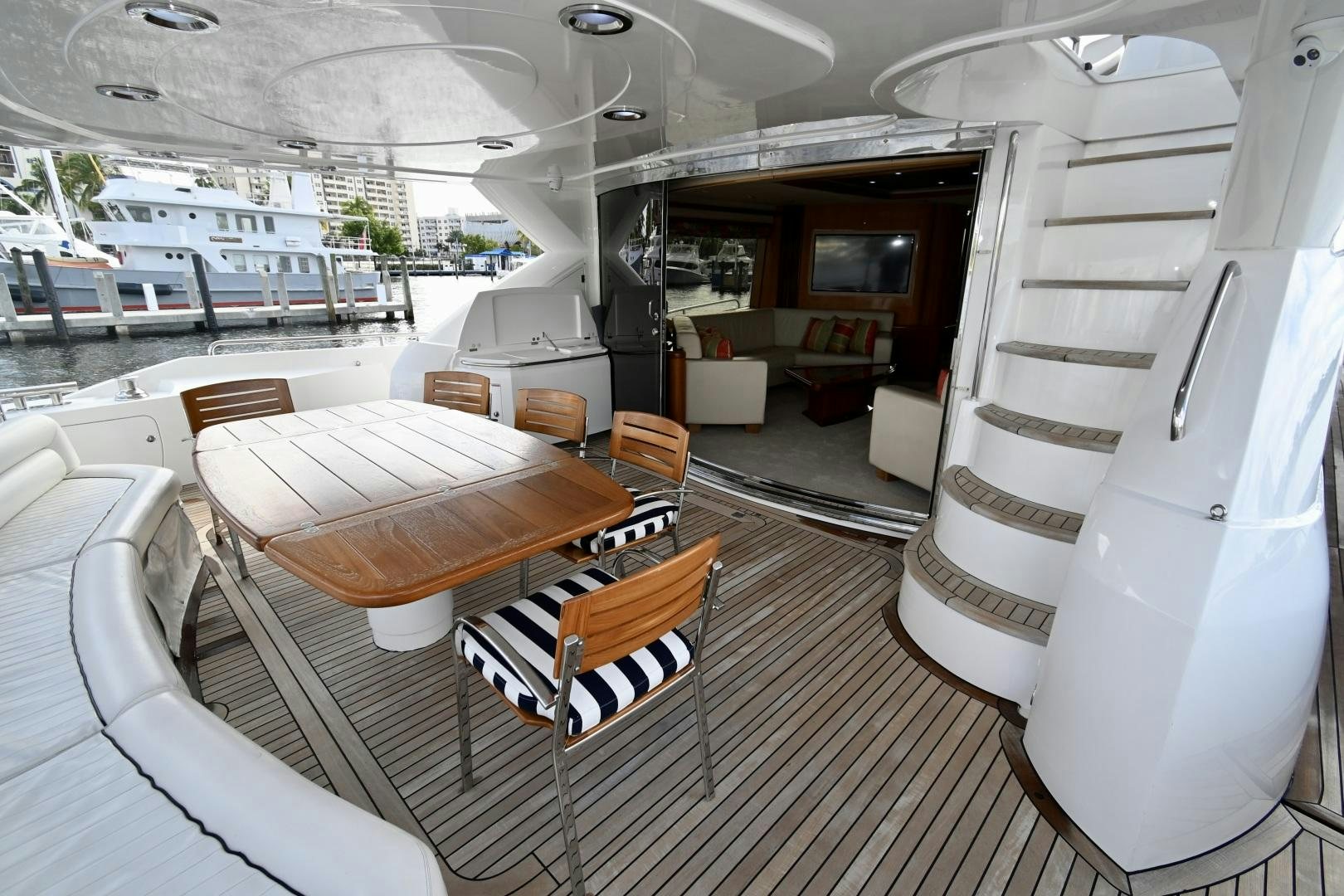 a boat with a table and chairs aboard BELLA Yacht for Sale