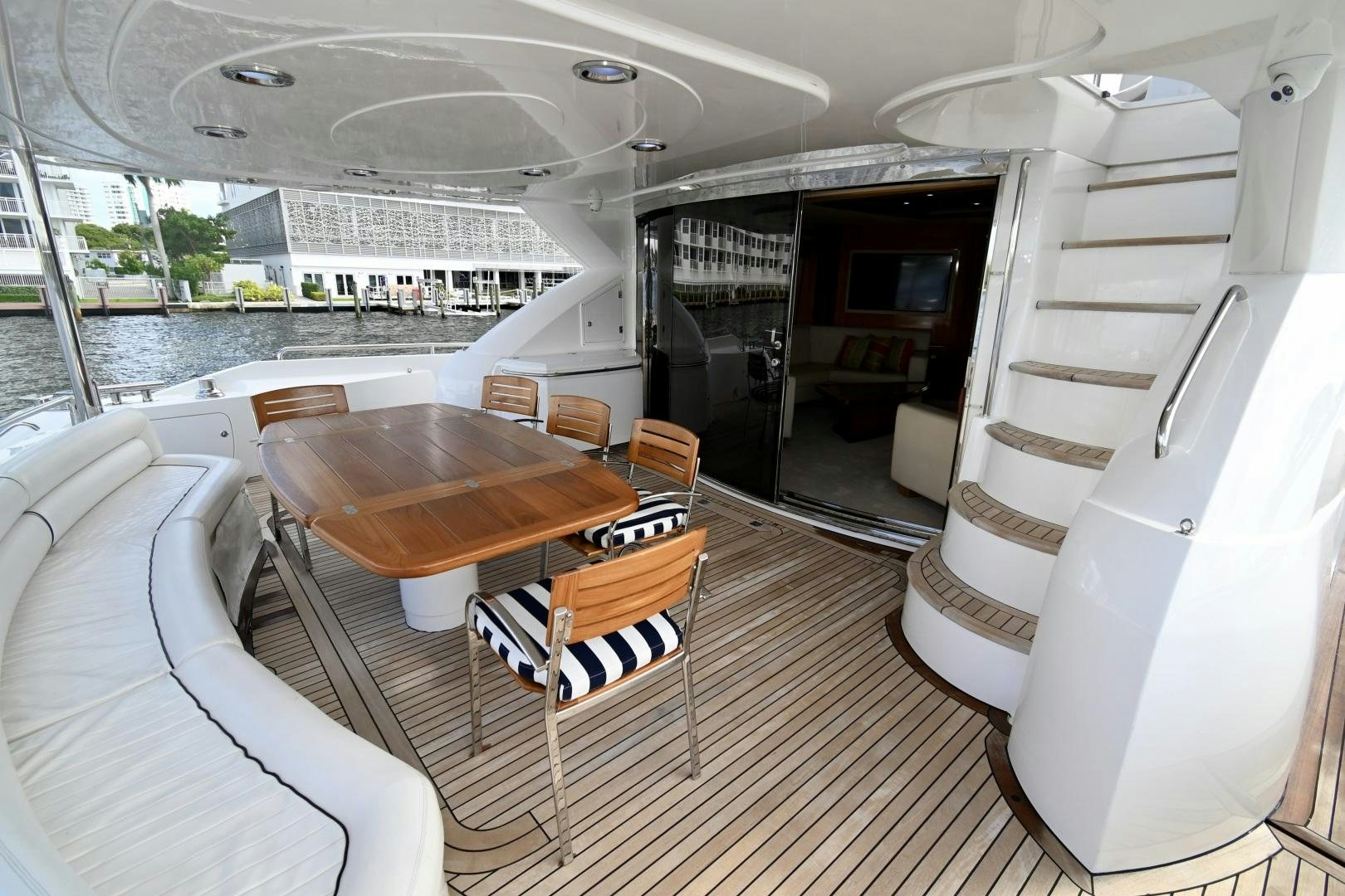 a boat with a table and chairs aboard BELLA Yacht for Sale