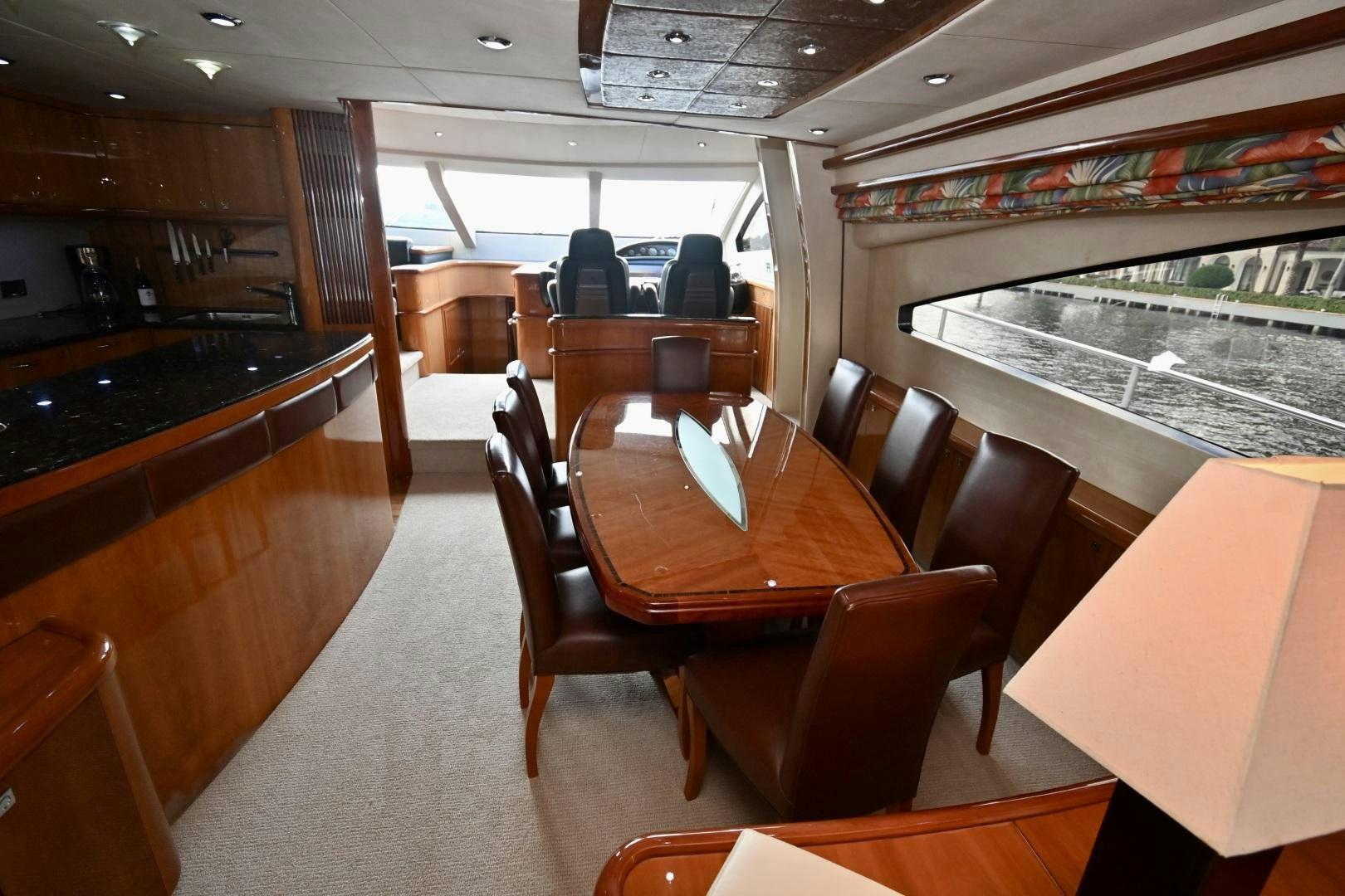 a restaurant with a large table and chairs aboard BELLA Yacht for Sale