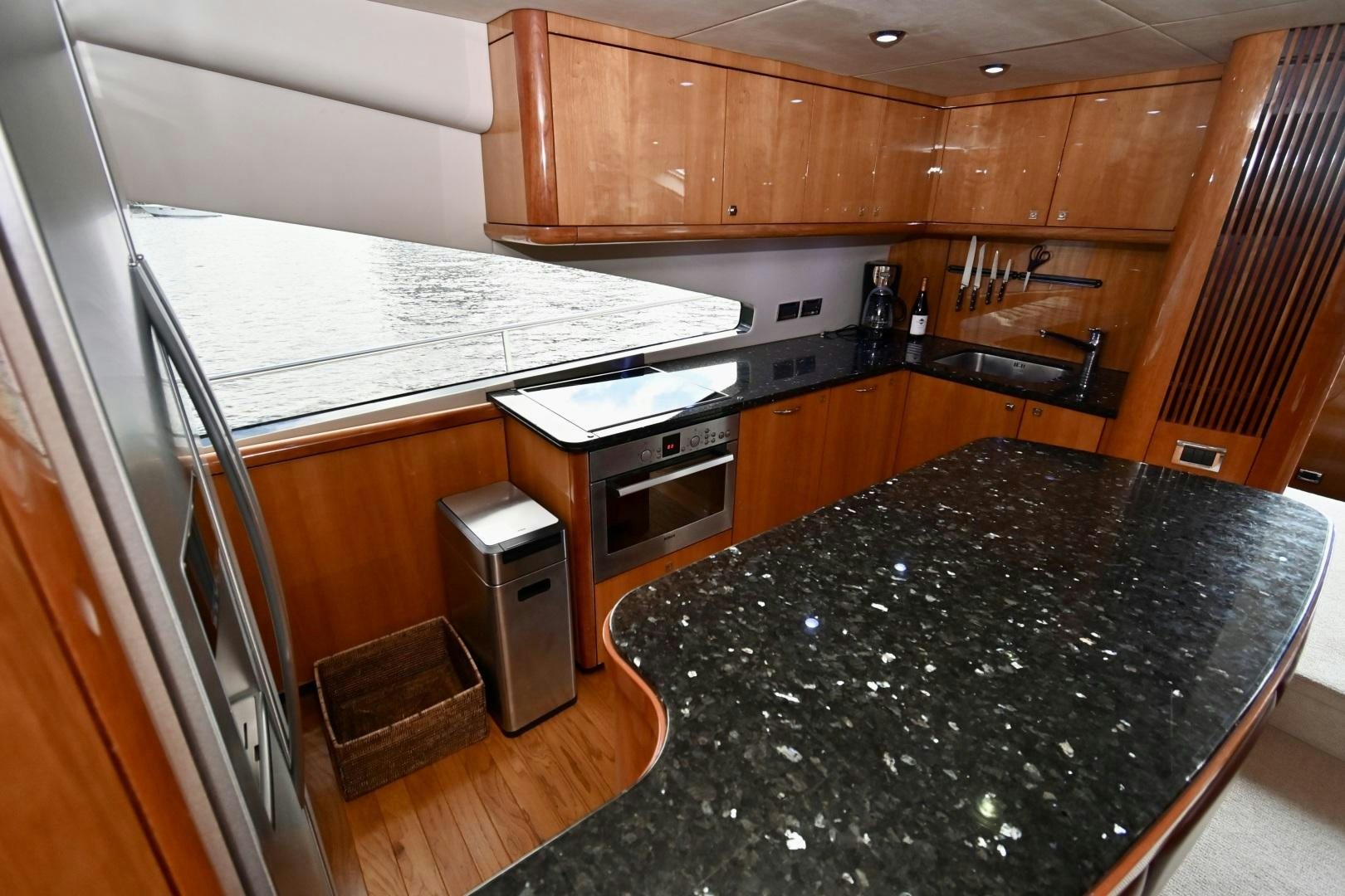 a kitchen with a large black counter aboard BELLA Yacht for Sale