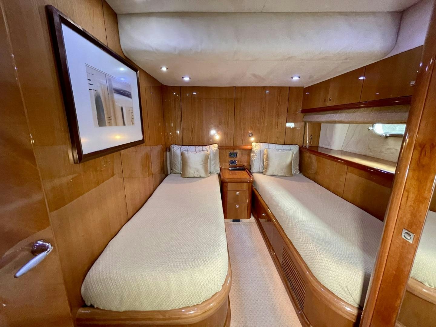 a room with a bed and a mirror aboard BELLA Yacht for Sale