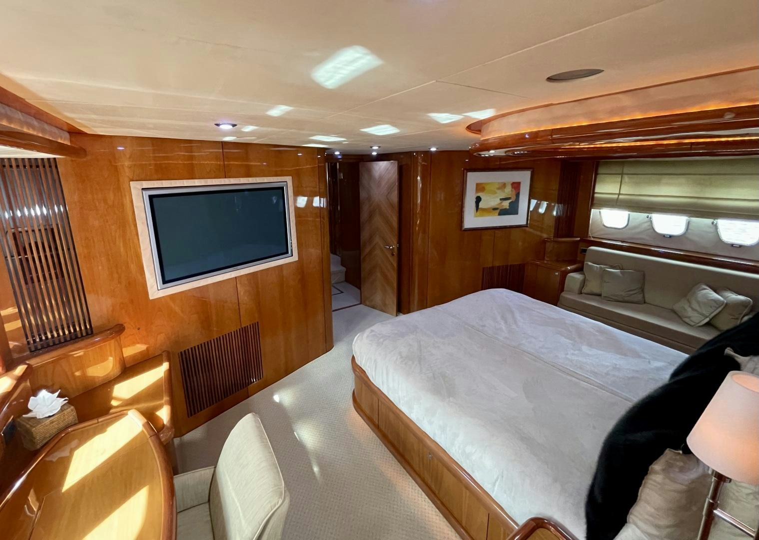 a room with a bed and a television aboard BELLA Yacht for Sale