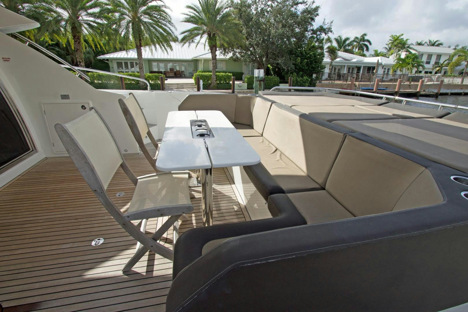 a deck with a table and chairs aboard MOODSWING Yacht for Sale