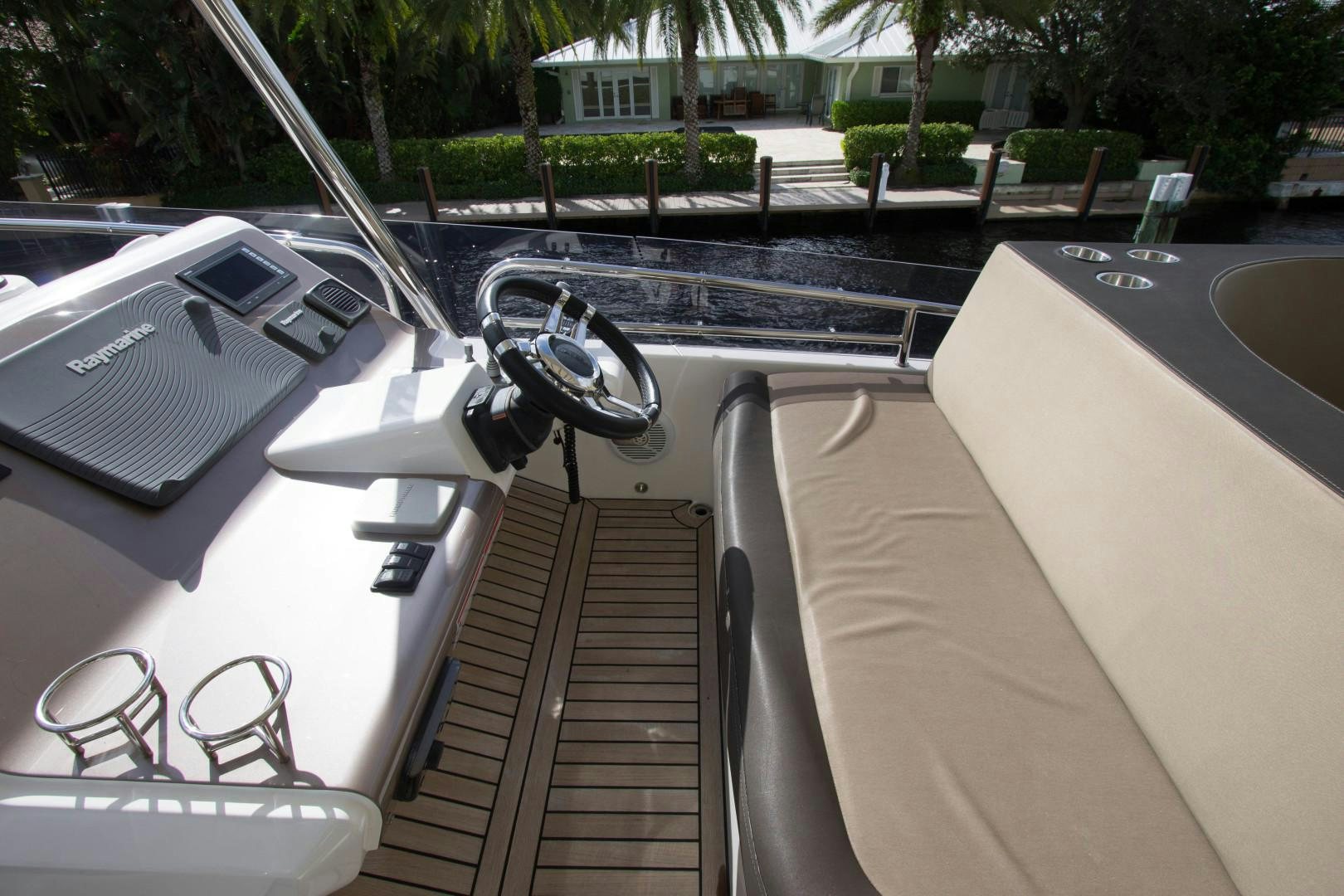 a car with a steering wheel and a deck and trees in the background aboard MOODSWING Yacht for Sale