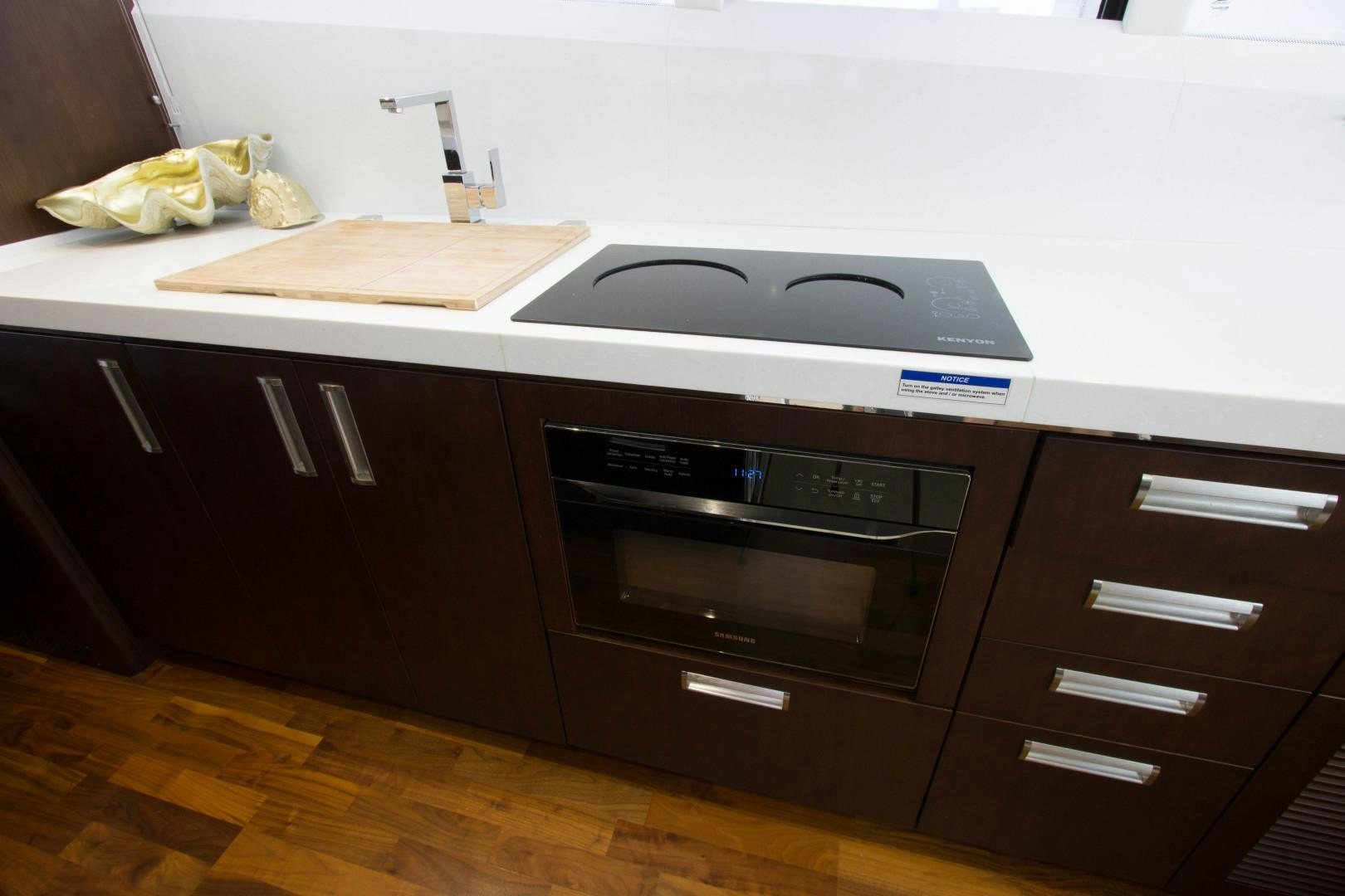 a kitchen with a stove and cabinets aboard MOODSWING Yacht for Sale