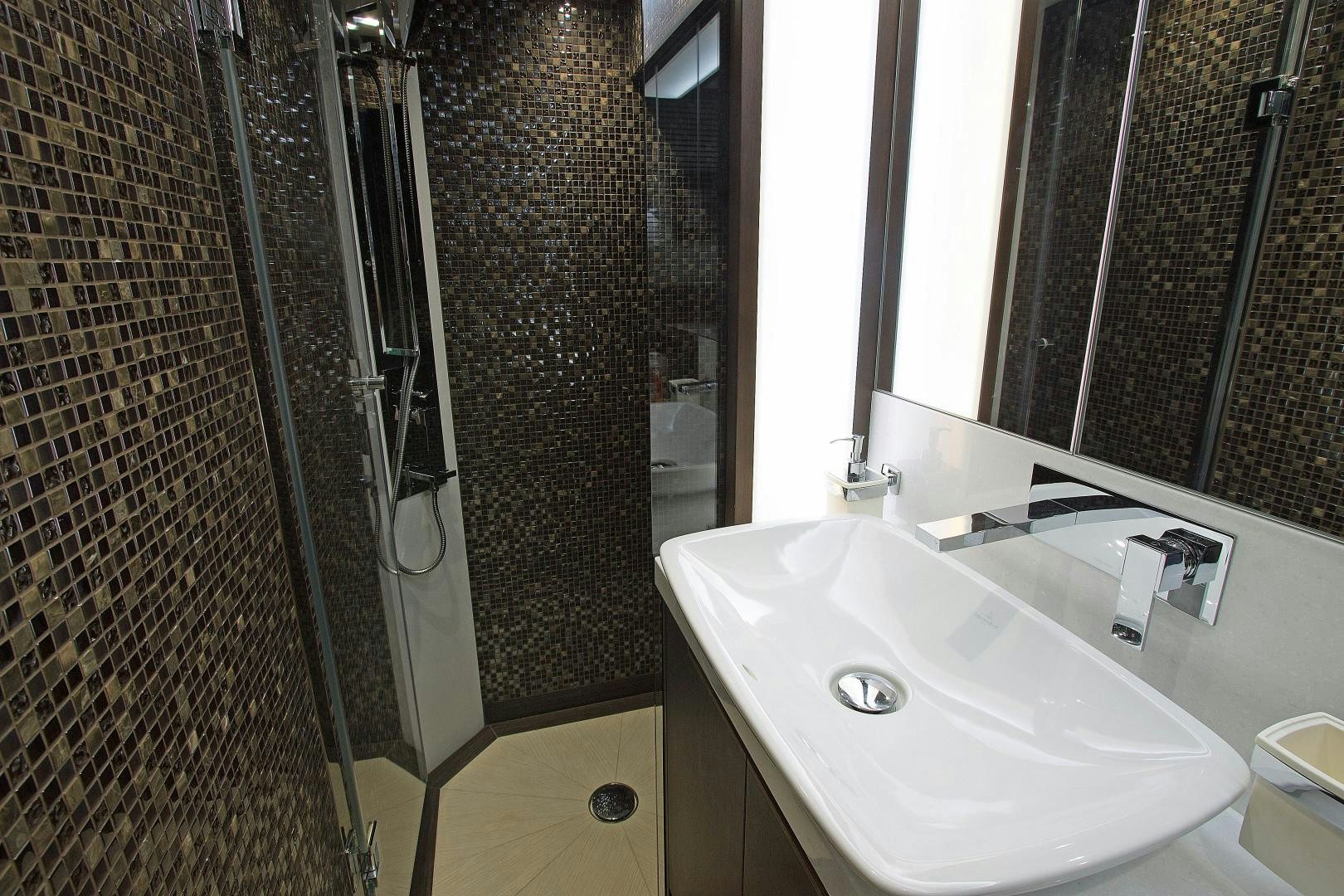 a bathroom with a sink and shower aboard MOODSWING Yacht for Sale