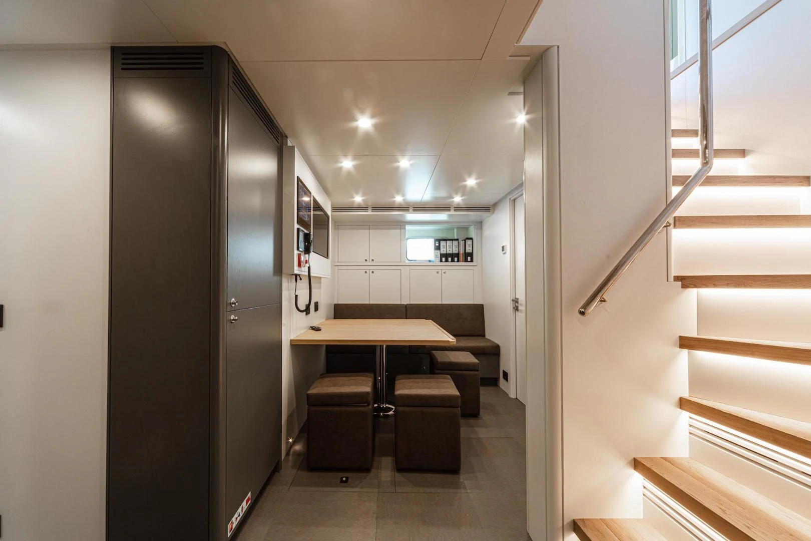 a hallway with a desk and a door aboard ATOM Yacht for Sale