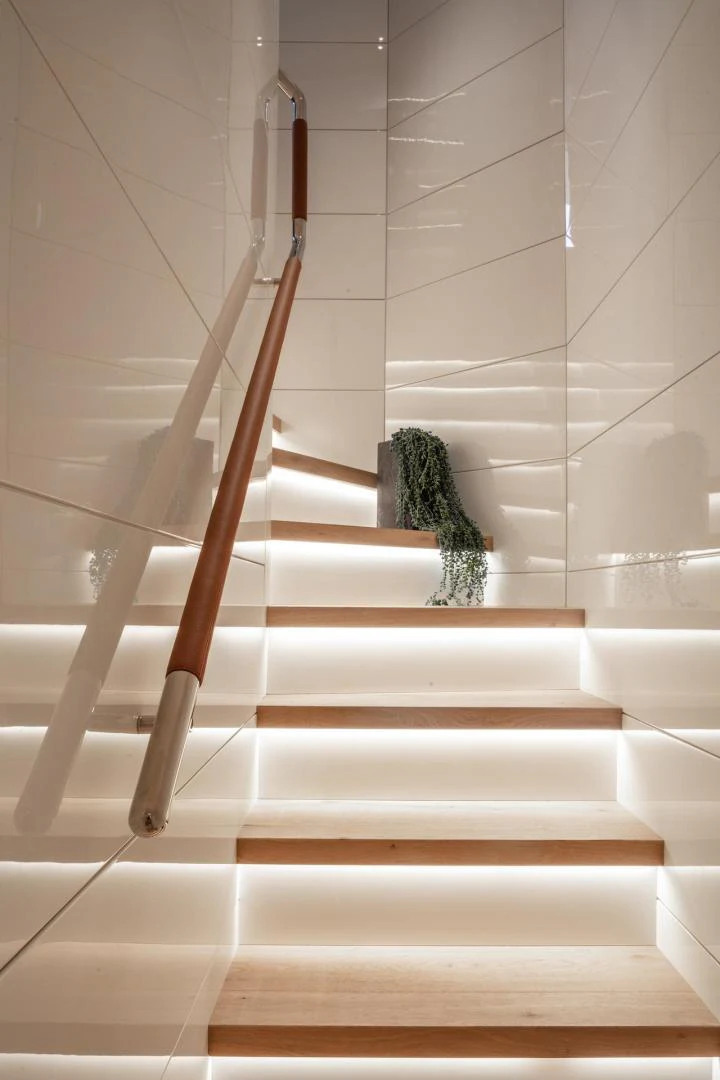 a cat sitting on a staircase aboard ATOM Yacht for Sale