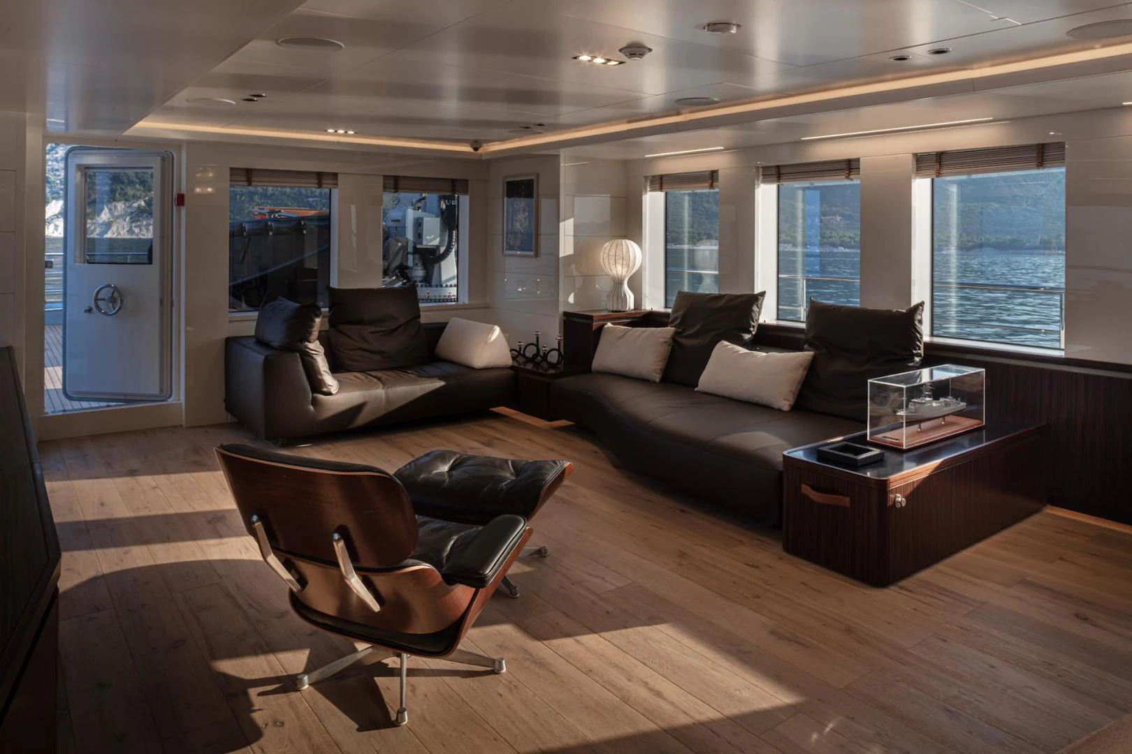 a living room with a leather couch and a coffee table aboard ATOM Yacht for Sale