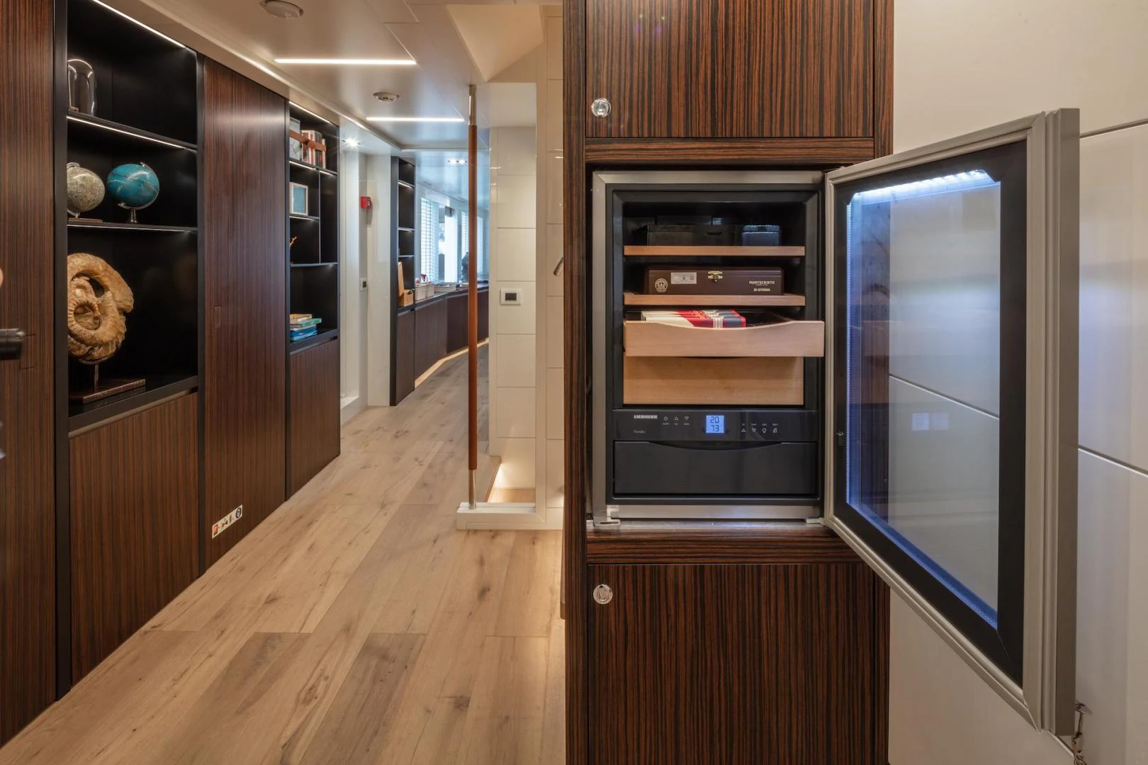 a wood cabinet in a room aboard ATOM Yacht for Sale