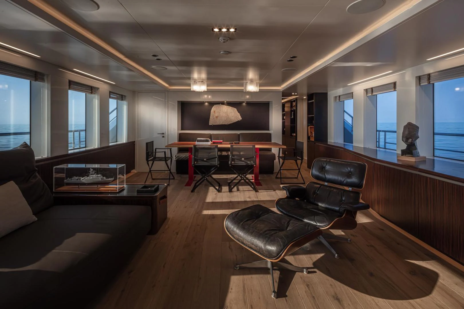 a living room with a leather couch and a tv aboard ATOM Yacht for Sale