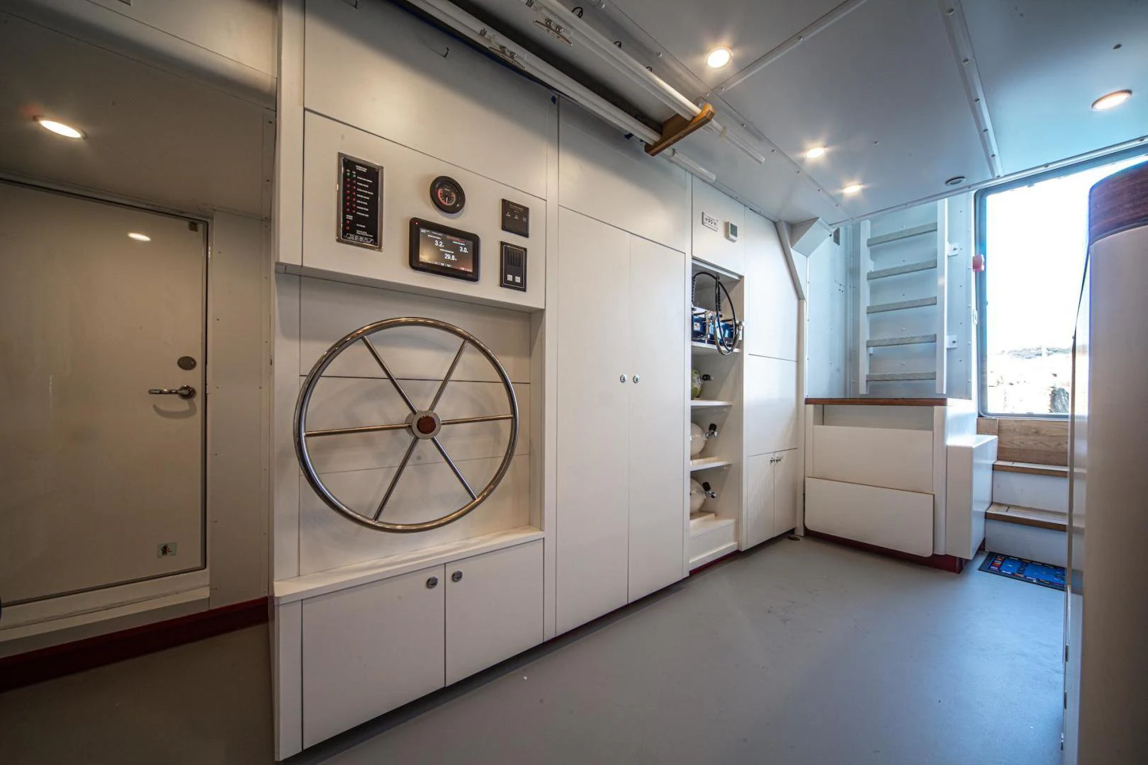 a room with a large white wall and a bicycle on the wall aboard ATOM Yacht for Sale