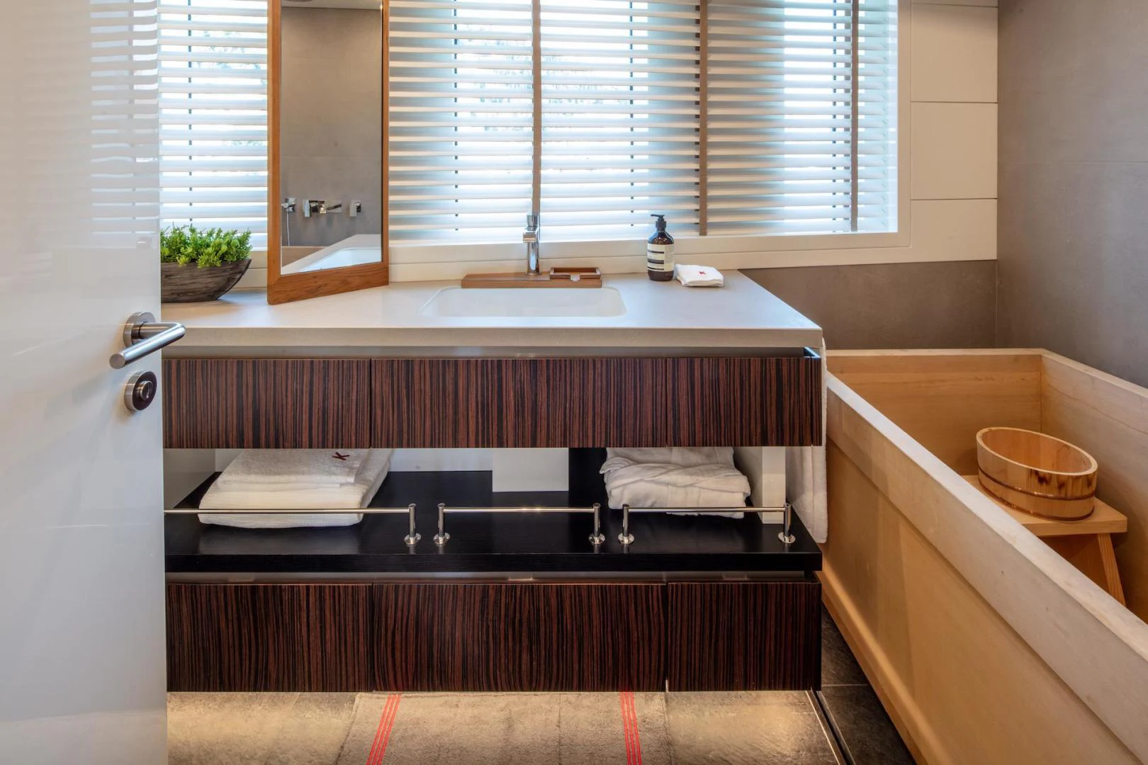 a bathroom with a sink and a tub aboard ATOM Yacht for Sale