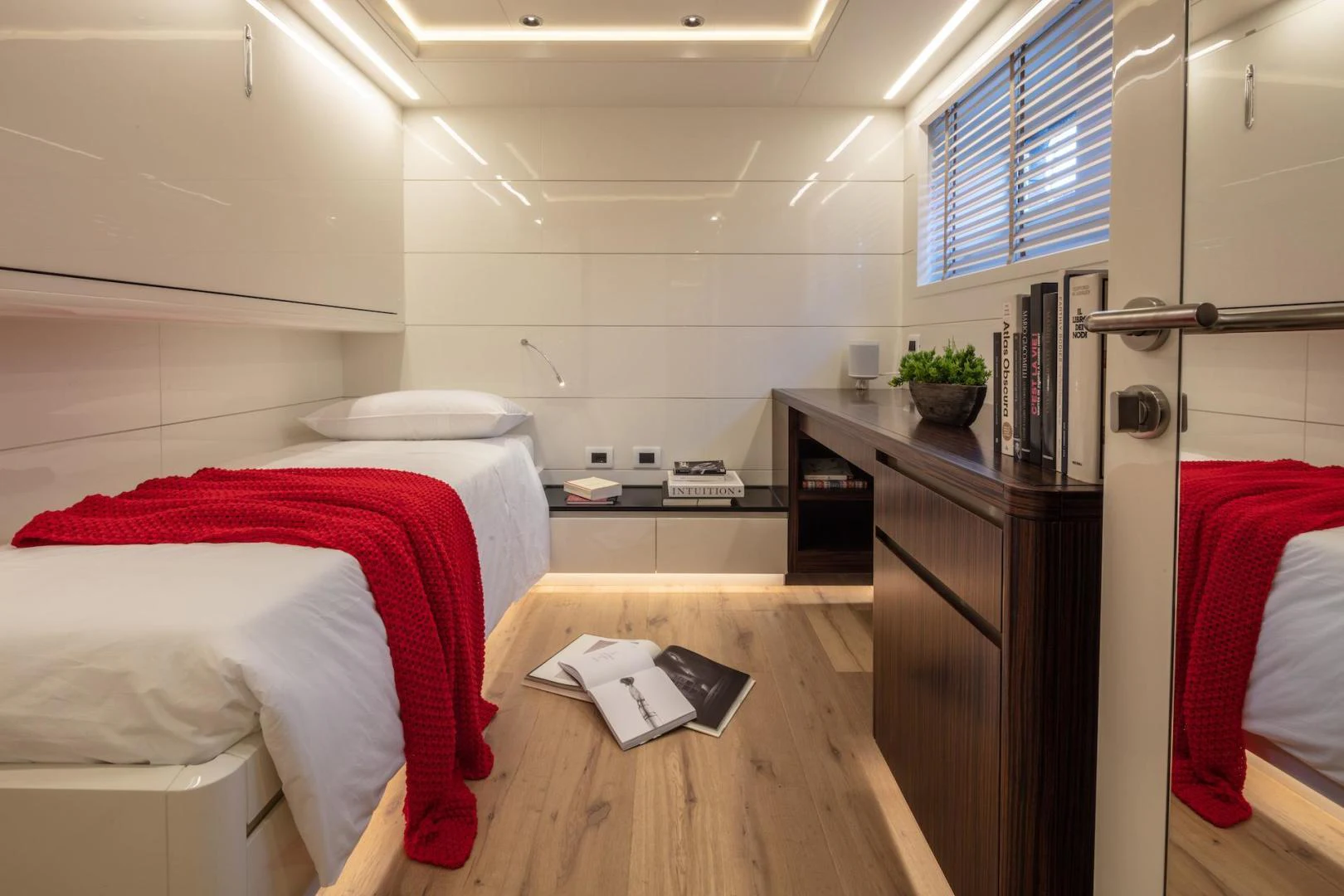 a small bedroom with a desk aboard ATOM Yacht for Sale