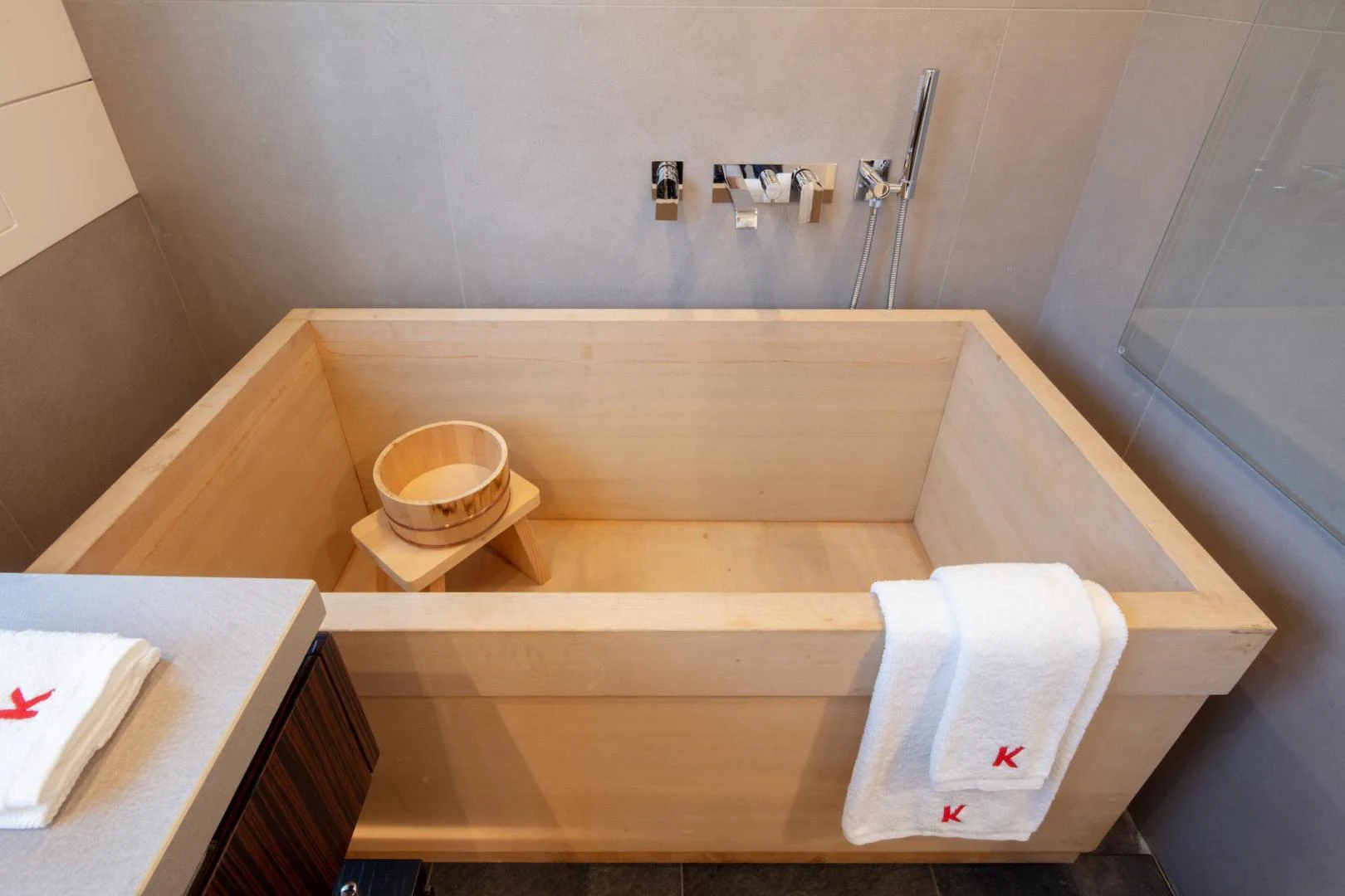 a bathroom with a sink and a basket aboard ATOM Yacht for Sale