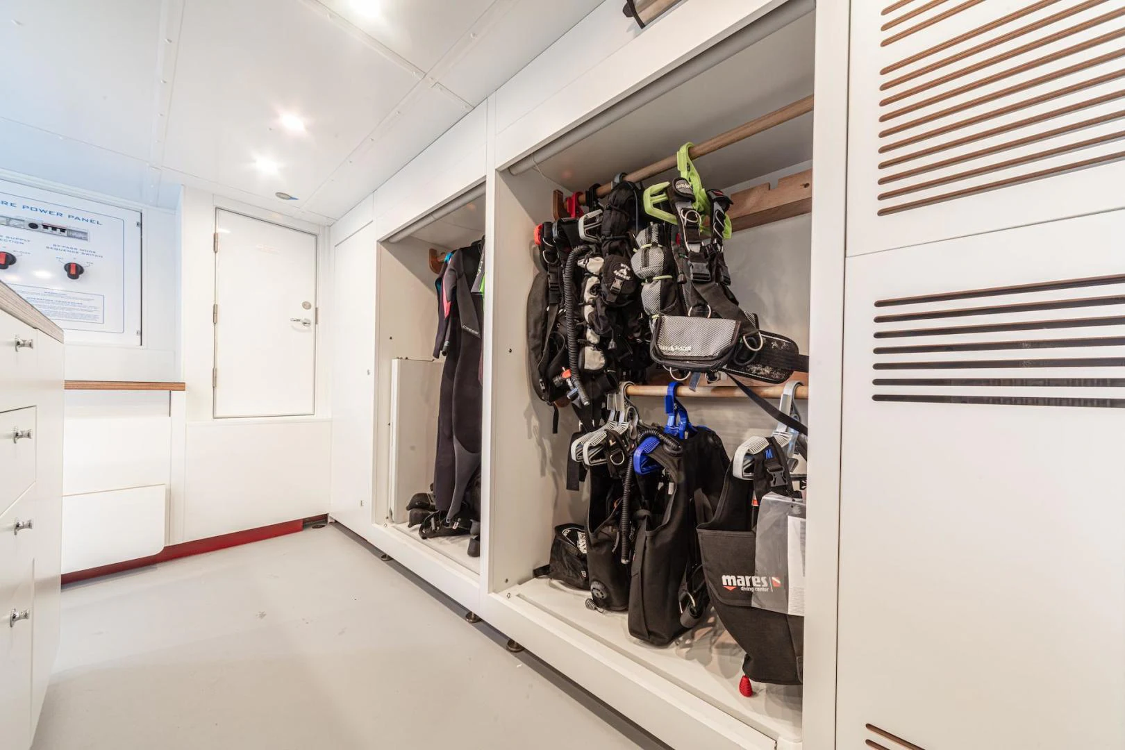 a room with a rack of clothes from the ceiling aboard ATOM Yacht for Sale