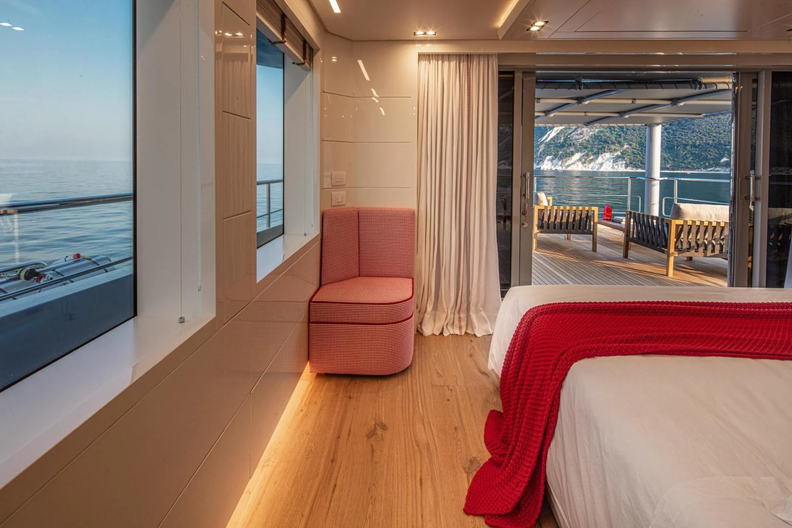 a room with a bed and a chair aboard ATOM Yacht for Sale