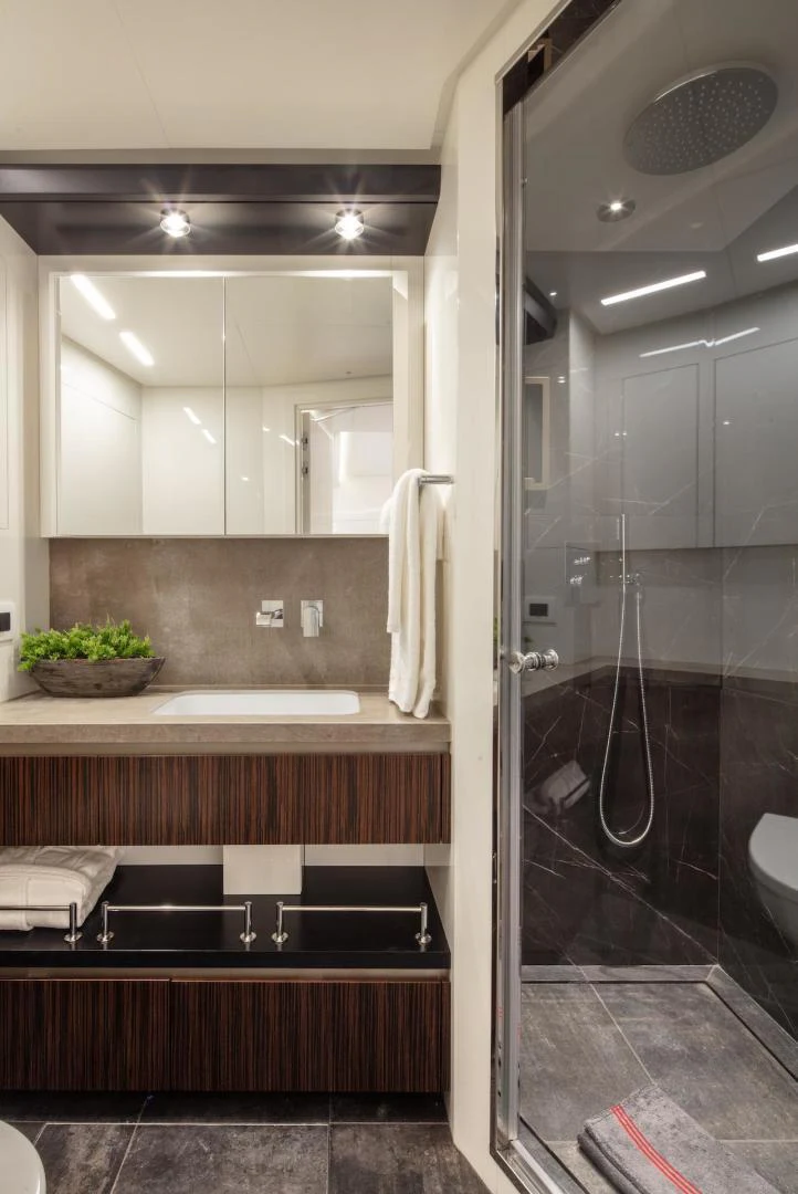 a bathroom with a glass shower aboard ATOM Yacht for Sale